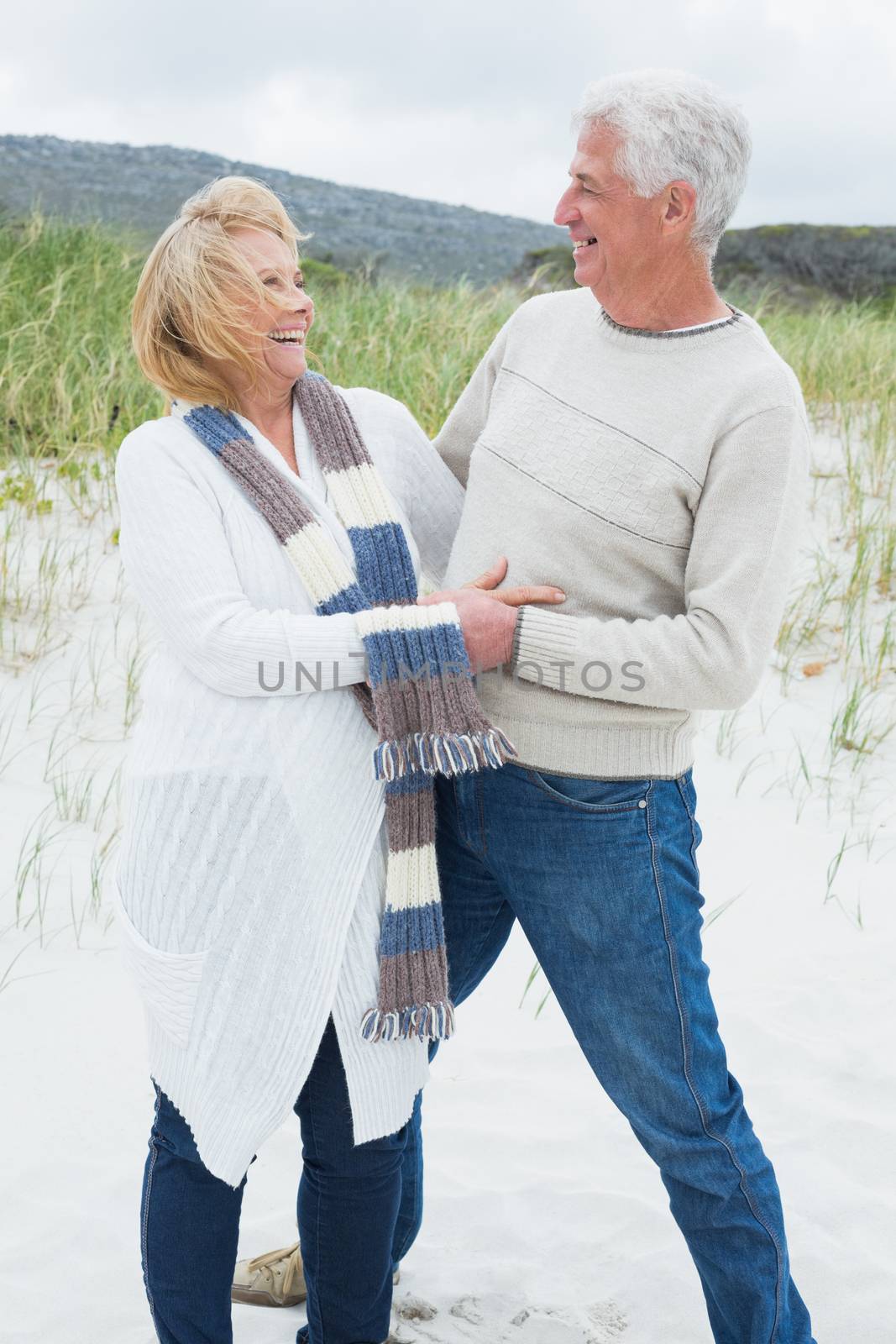 Cheerful romantic senior couple at beach by Wavebreakmedia