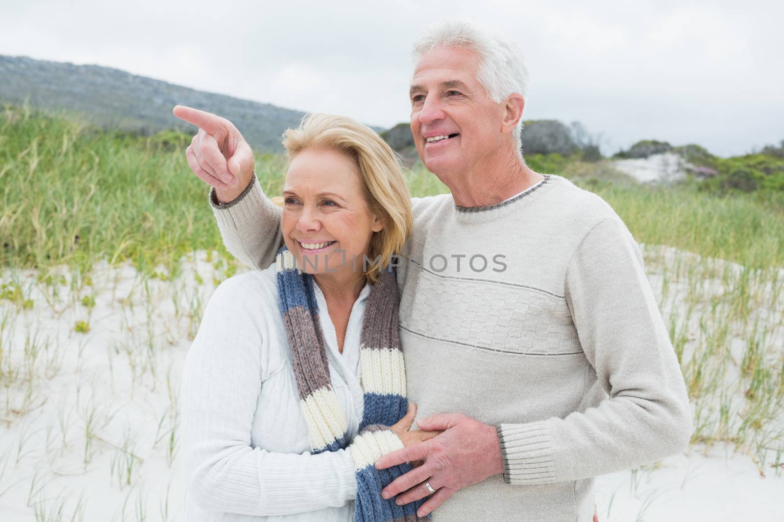Cheerful romantic senior man and woman at the beach