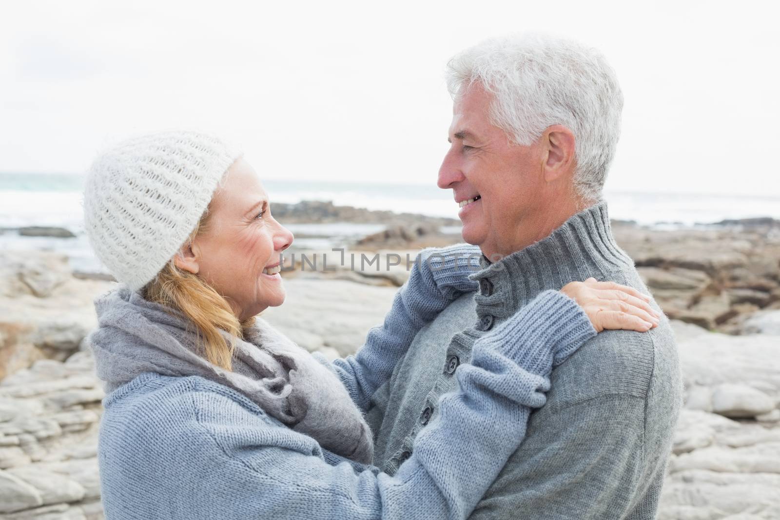 Side view of a romantic senior couple together on a rocky landscape