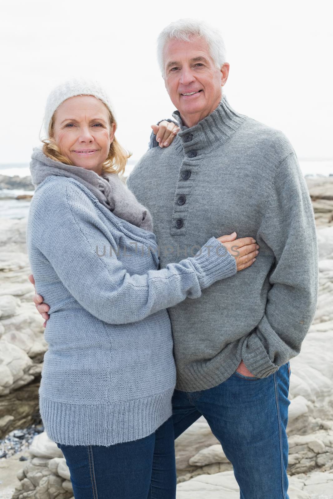 Romantic senior couple on rocky beach by Wavebreakmedia