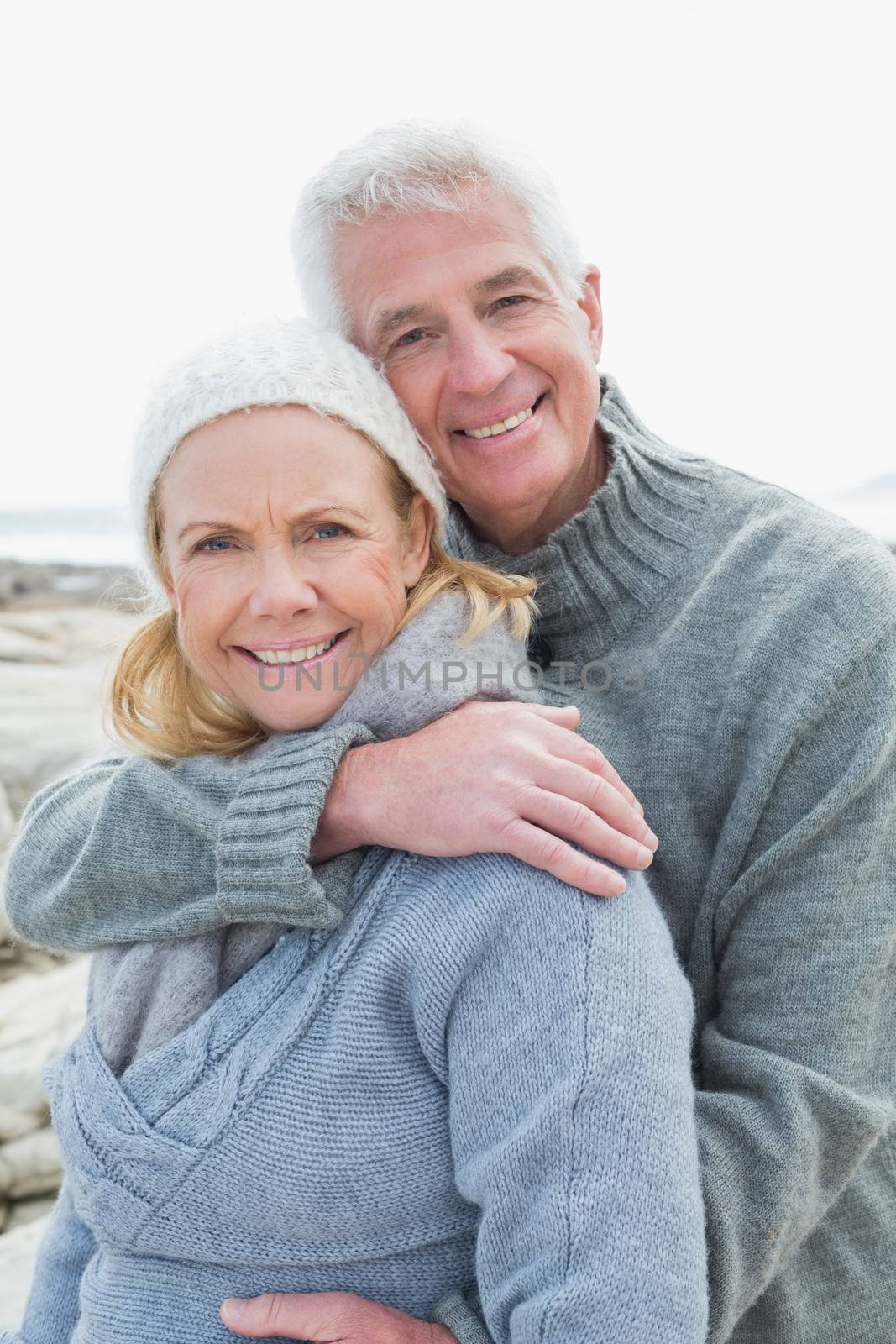 Romantic senior couple on rocky beach by Wavebreakmedia