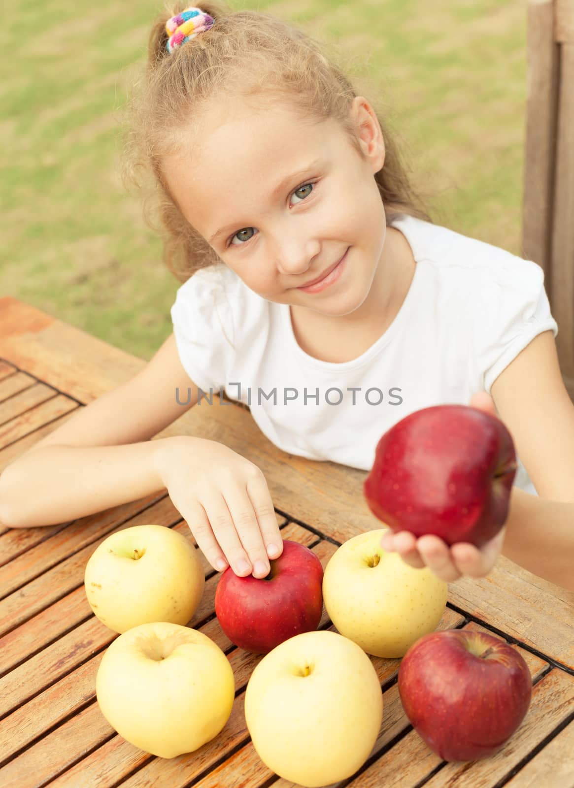 portrait of a happy child with apples