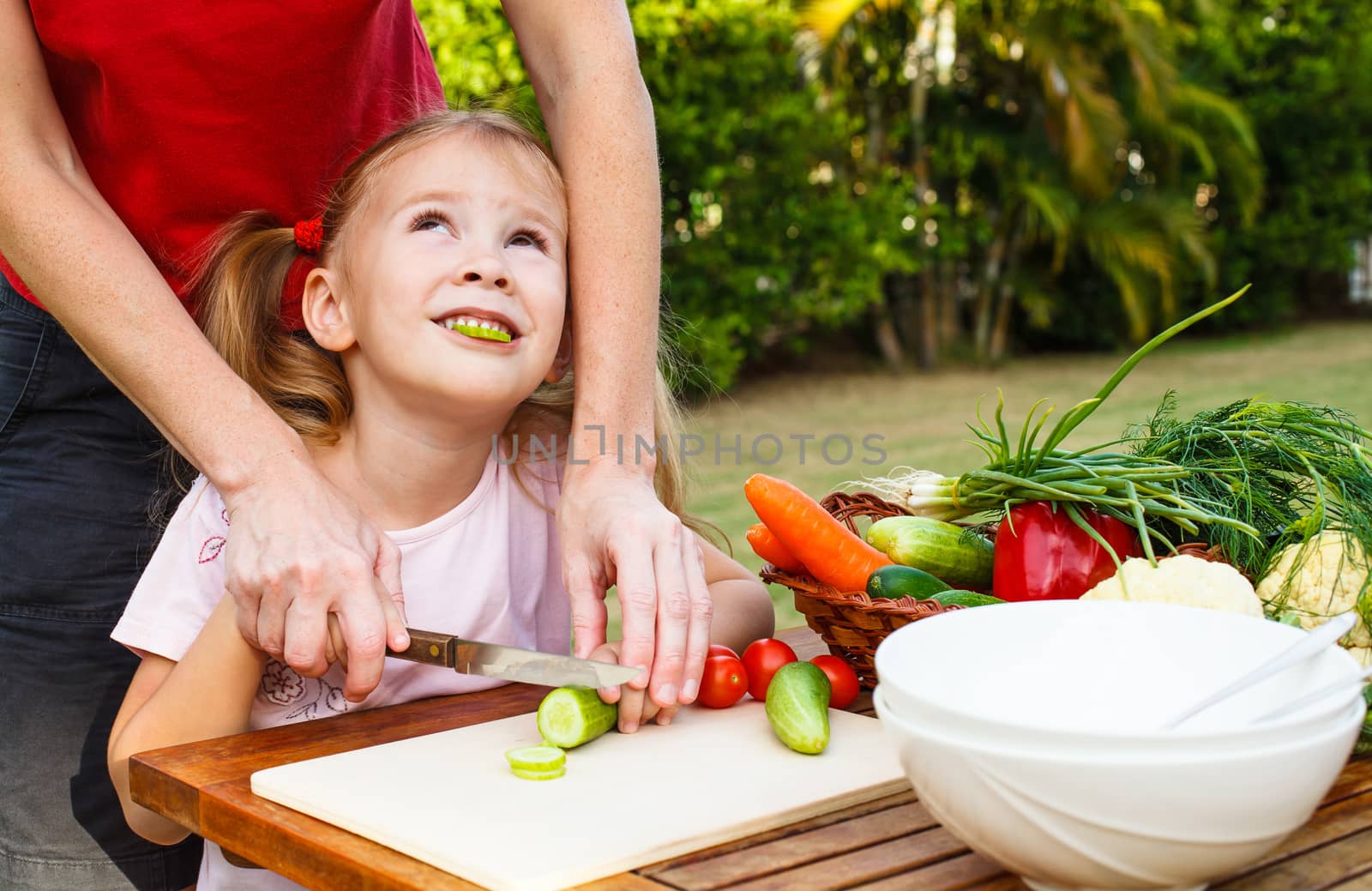 mother teaches daughter  knife cut cucumber by altanaka