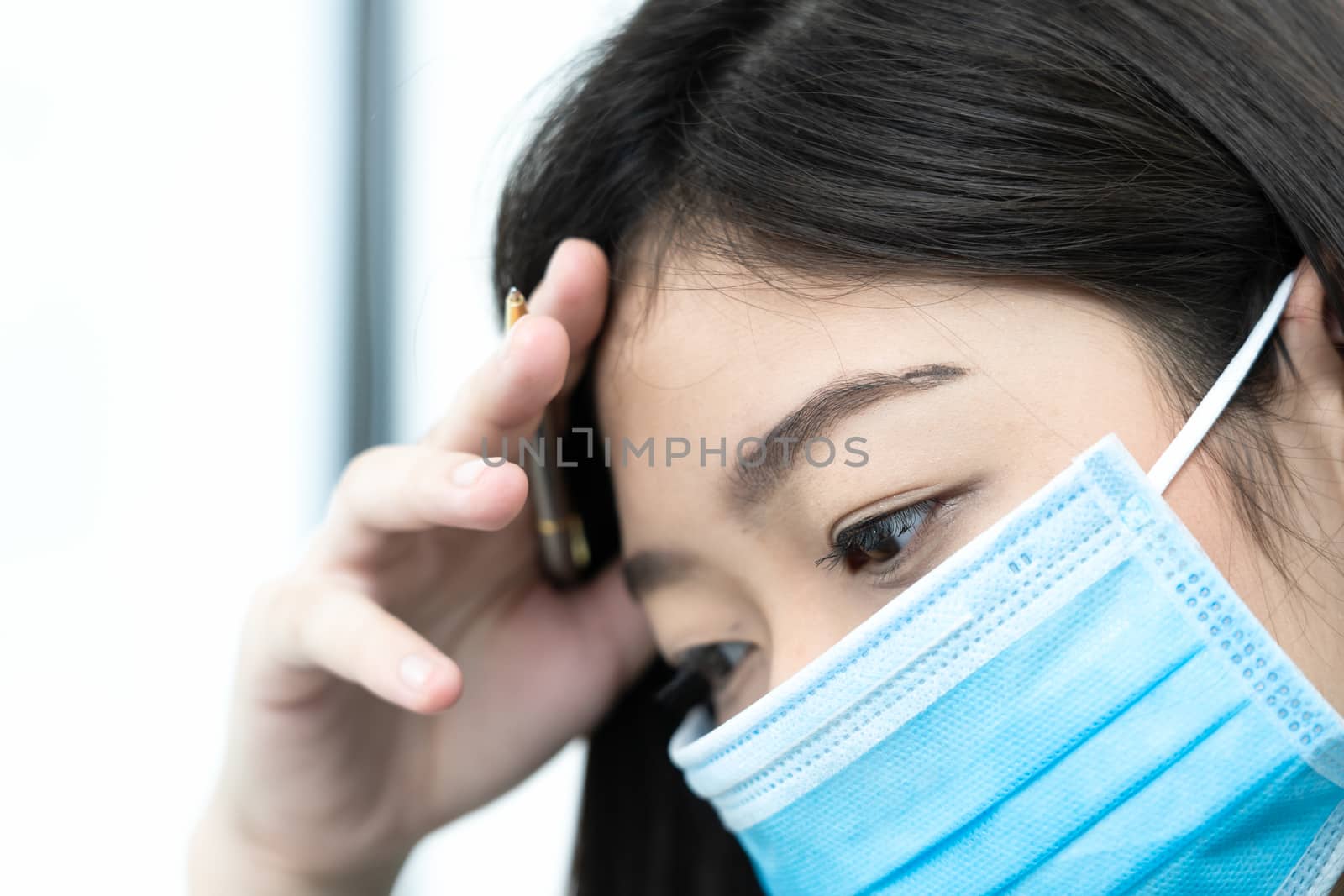 Close up woman with headache wearing mask for protect Covid-19 by stoonn
