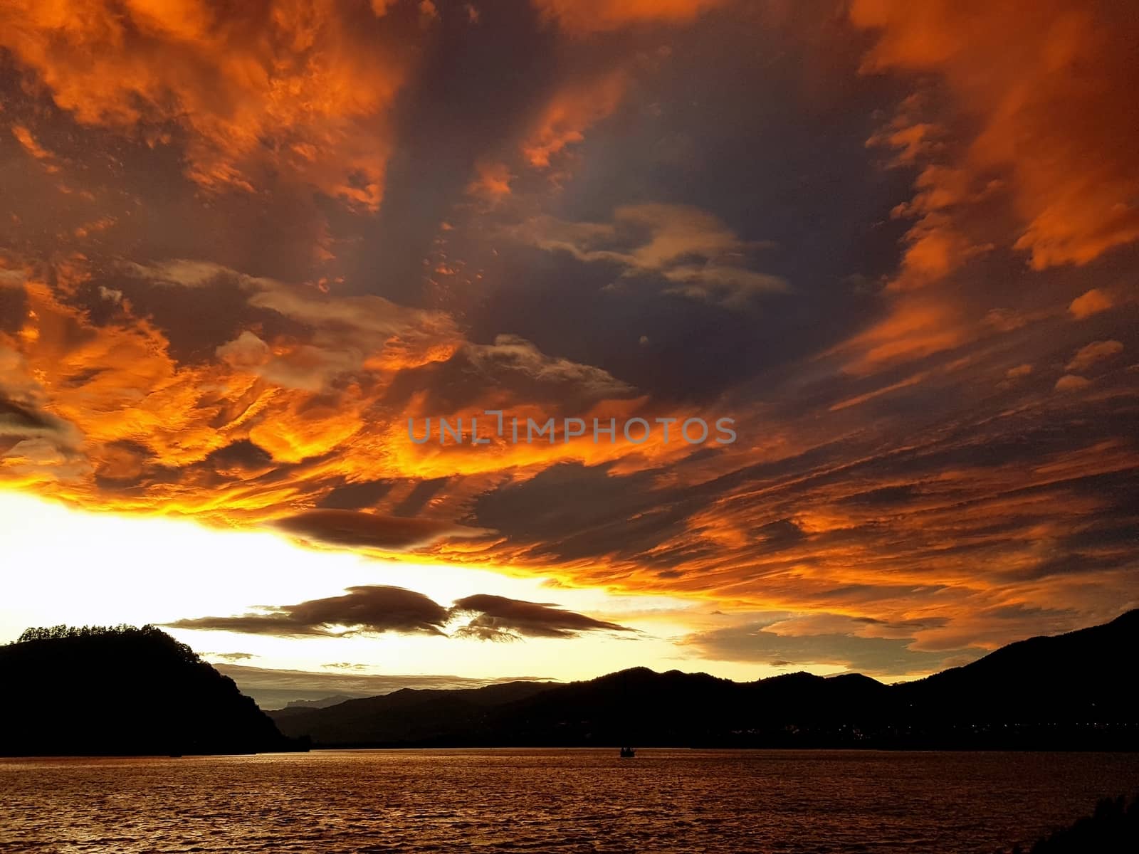 Orange sky landscape after sunset over the lake