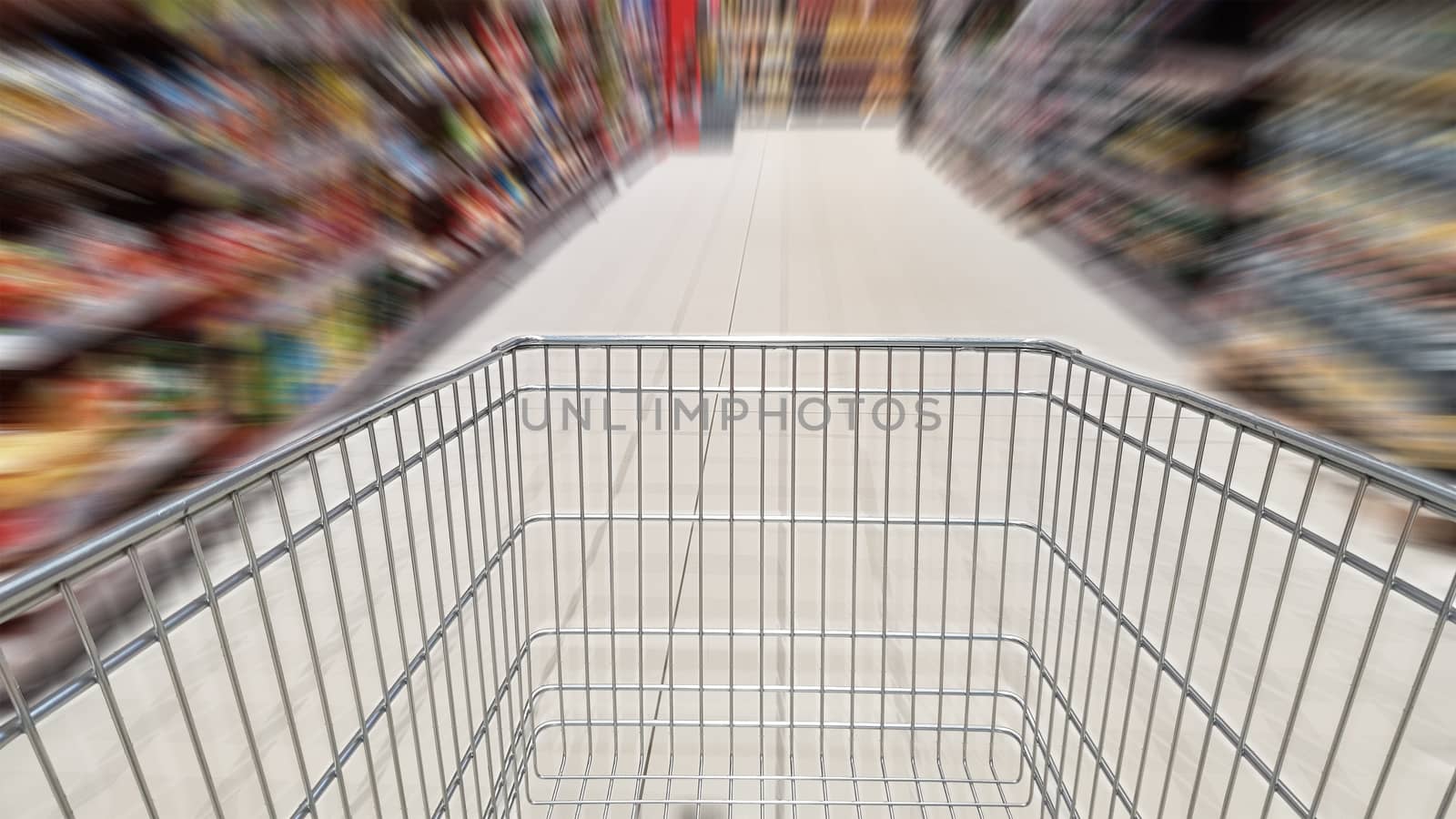 Shopping cart and motion blur in supermarket aisle