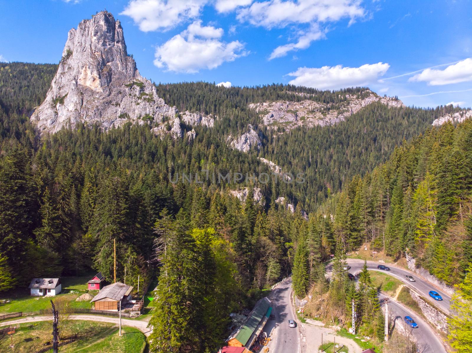 Aerial view of a curvy road in the mountains, summer landscape