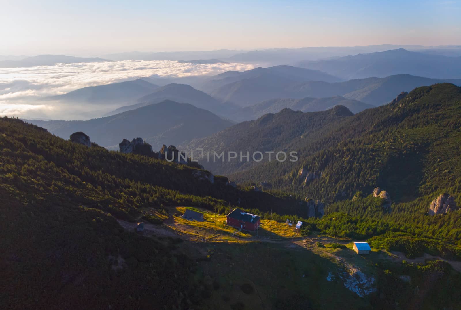 Mountain shelter and forest landscape at sunrise