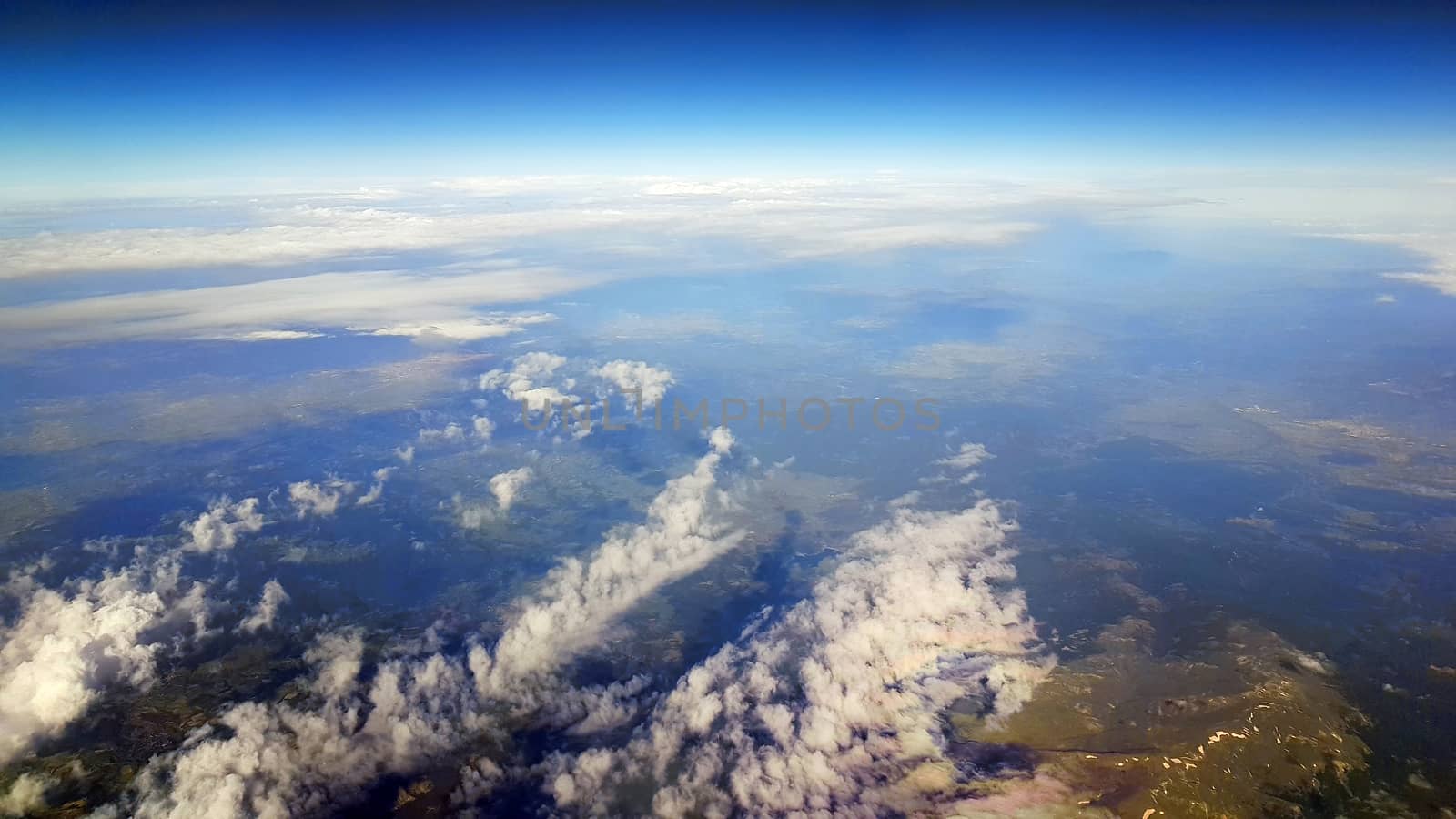 Plane view above Turkey, aerial view of land  and clouds with blue sky.