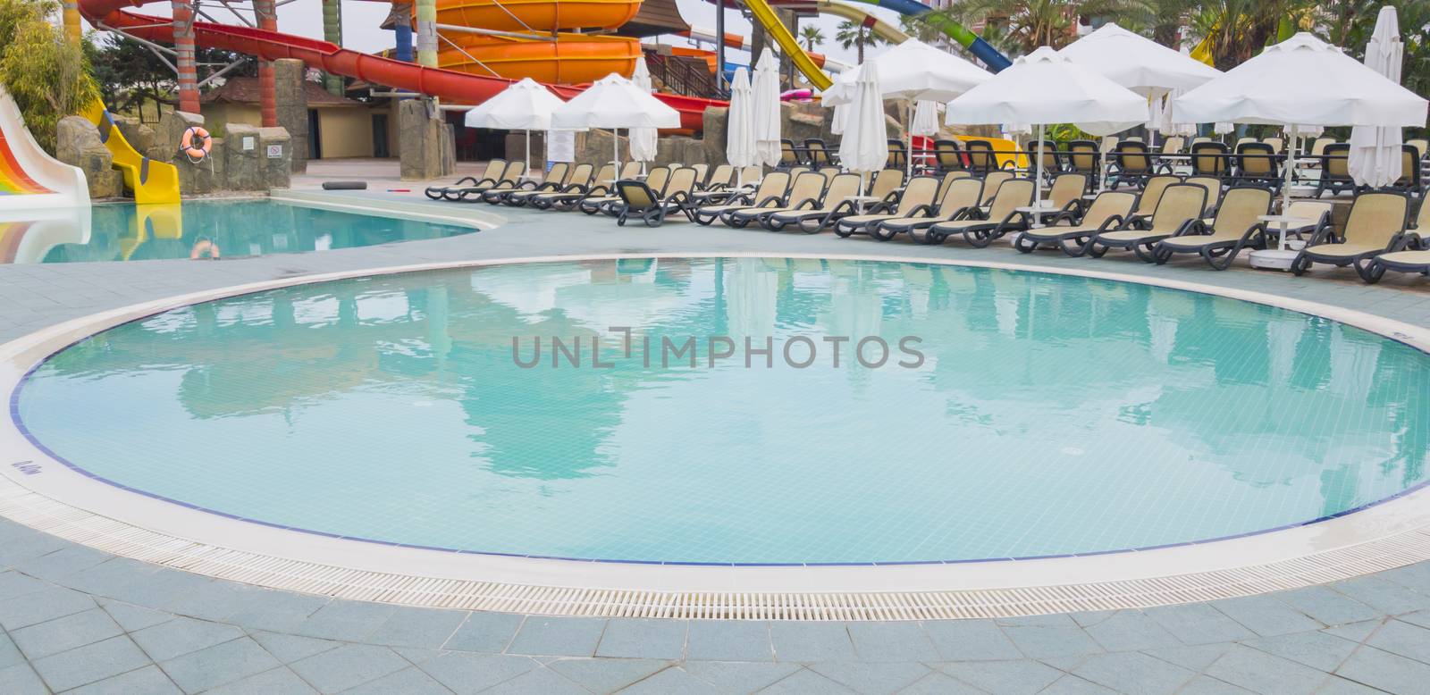 Childs swimming pool and chaise loungues for parents, water park behind