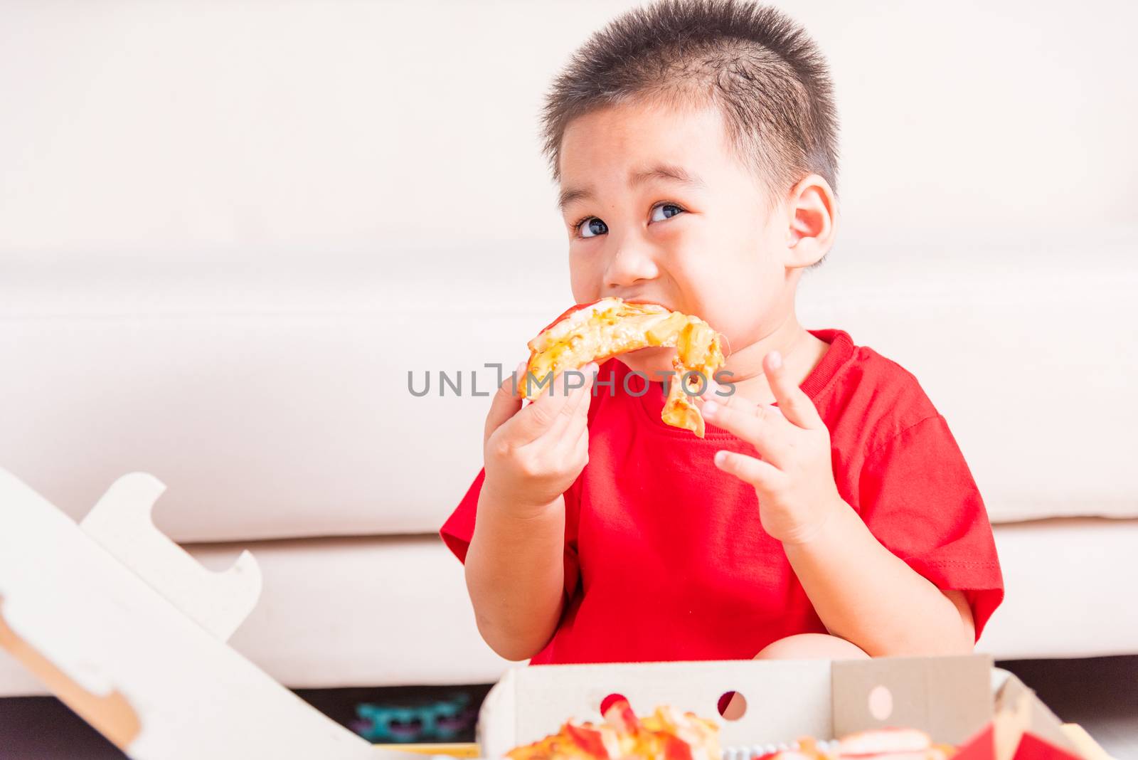 Hot Homemade, Vegetarian fast Italian food, Cute Little Child enjoying eating Delivery Pizza pepperoni, cheese many slices deliciously in an open cardboard box at home