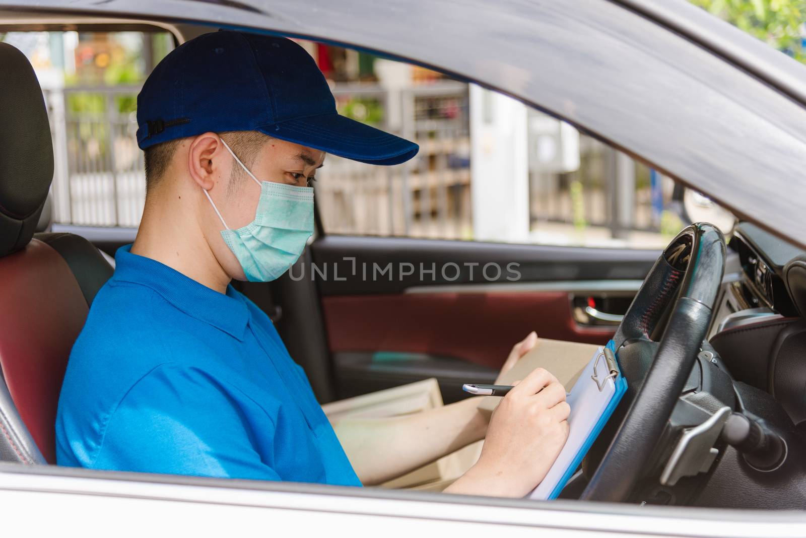 delivery courier young man driver inside the van car with parcel by Sorapop