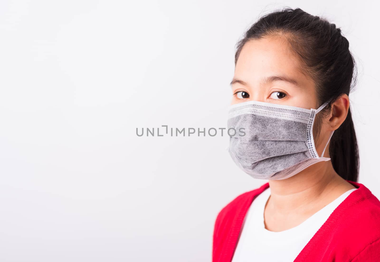 Asian adult woman wearing red shirt and face mask protective against coronavirus or COVID-19 virus or filter dust pm2.5 and air pollution she looking camera, studio shot isolated white background