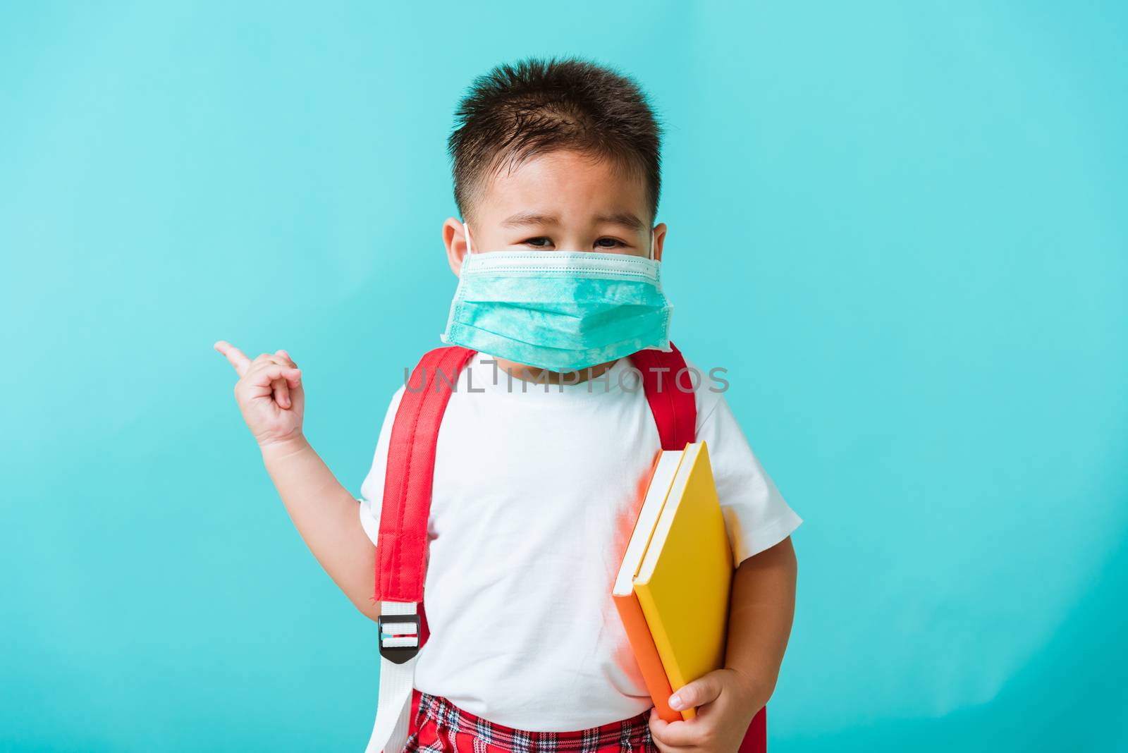 child boy kindergarten wear face mask protective and school bag  by Sorapop
