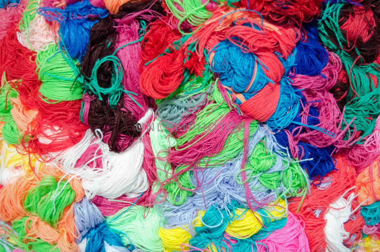 Yarn mess colourful background by BasPhoto