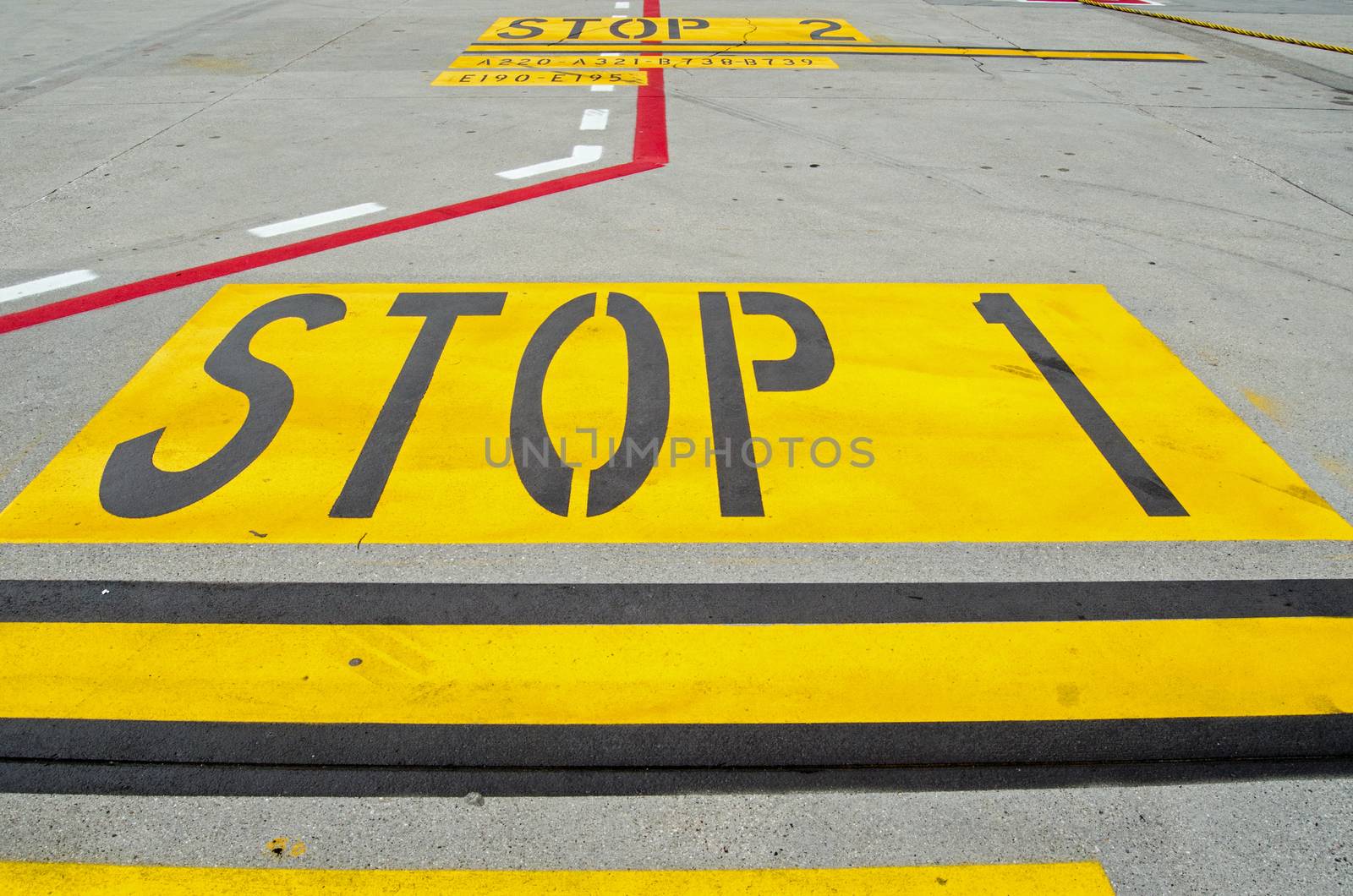 Stop sign painted on the airport apron as an instruction for the pilot at Marco Polo Airport in Venice, Italy.