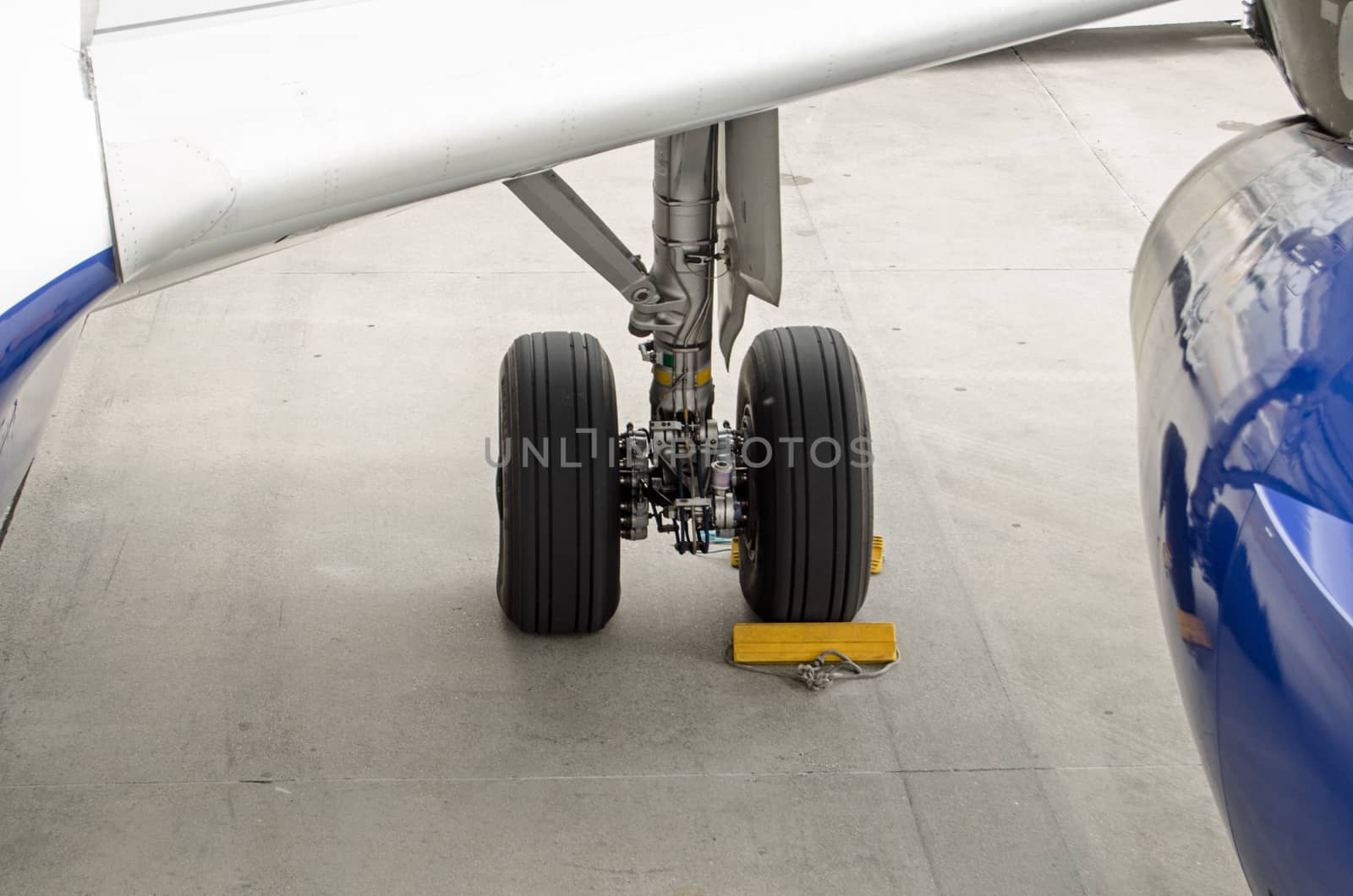 Chocks securing a plane undercarriage. by BasPhoto