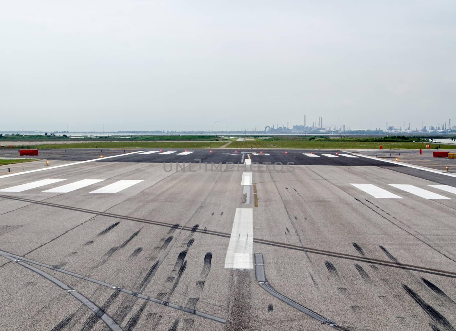 End of the runway, with skid marks from landings at Marco Polo Airport, Venice, Italy.