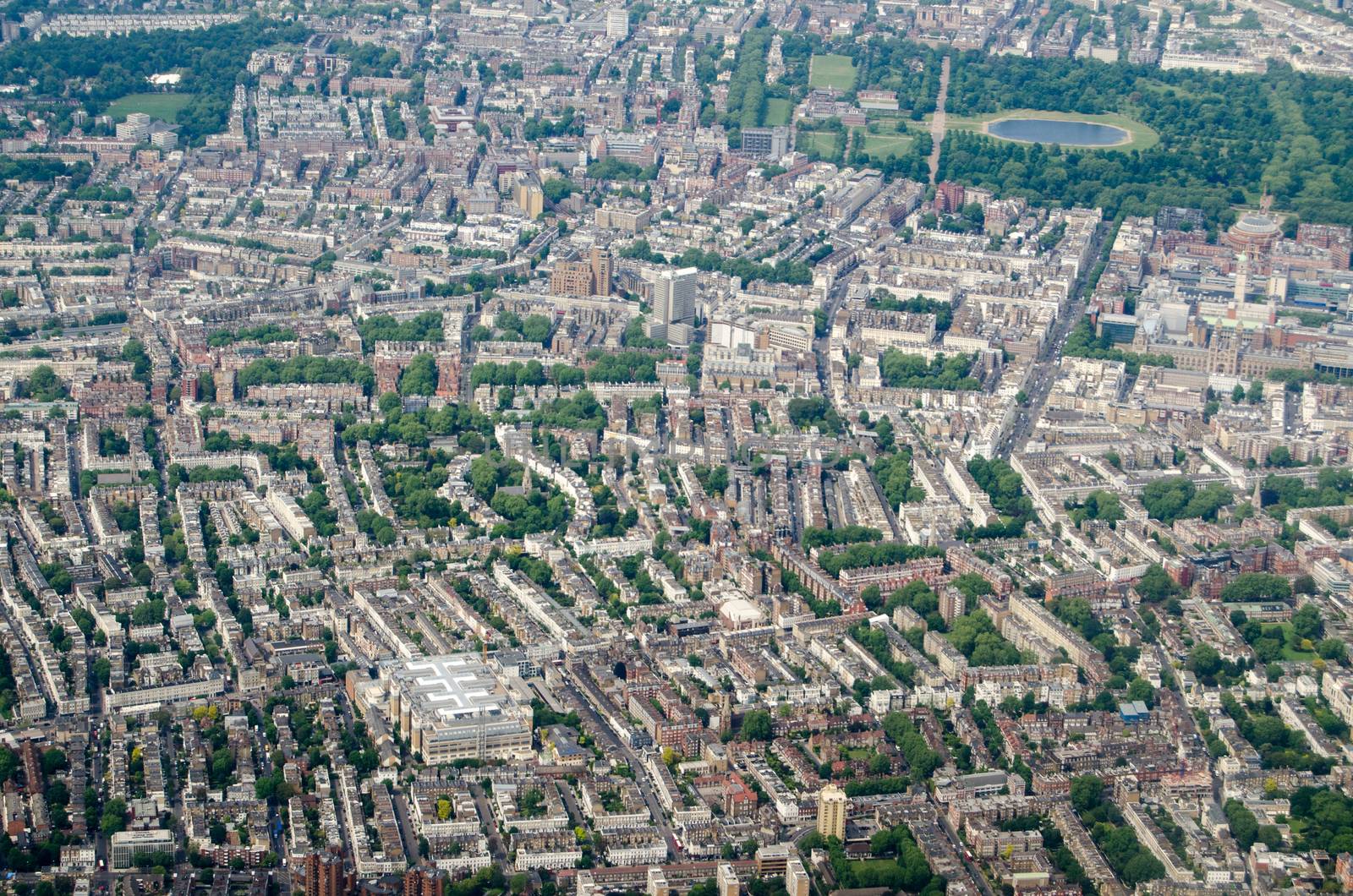 Aerial view looking north across the wealthy districts of Chelsea and West Kensington with Hyde Park to the top of the picture on a sunny morning in London.