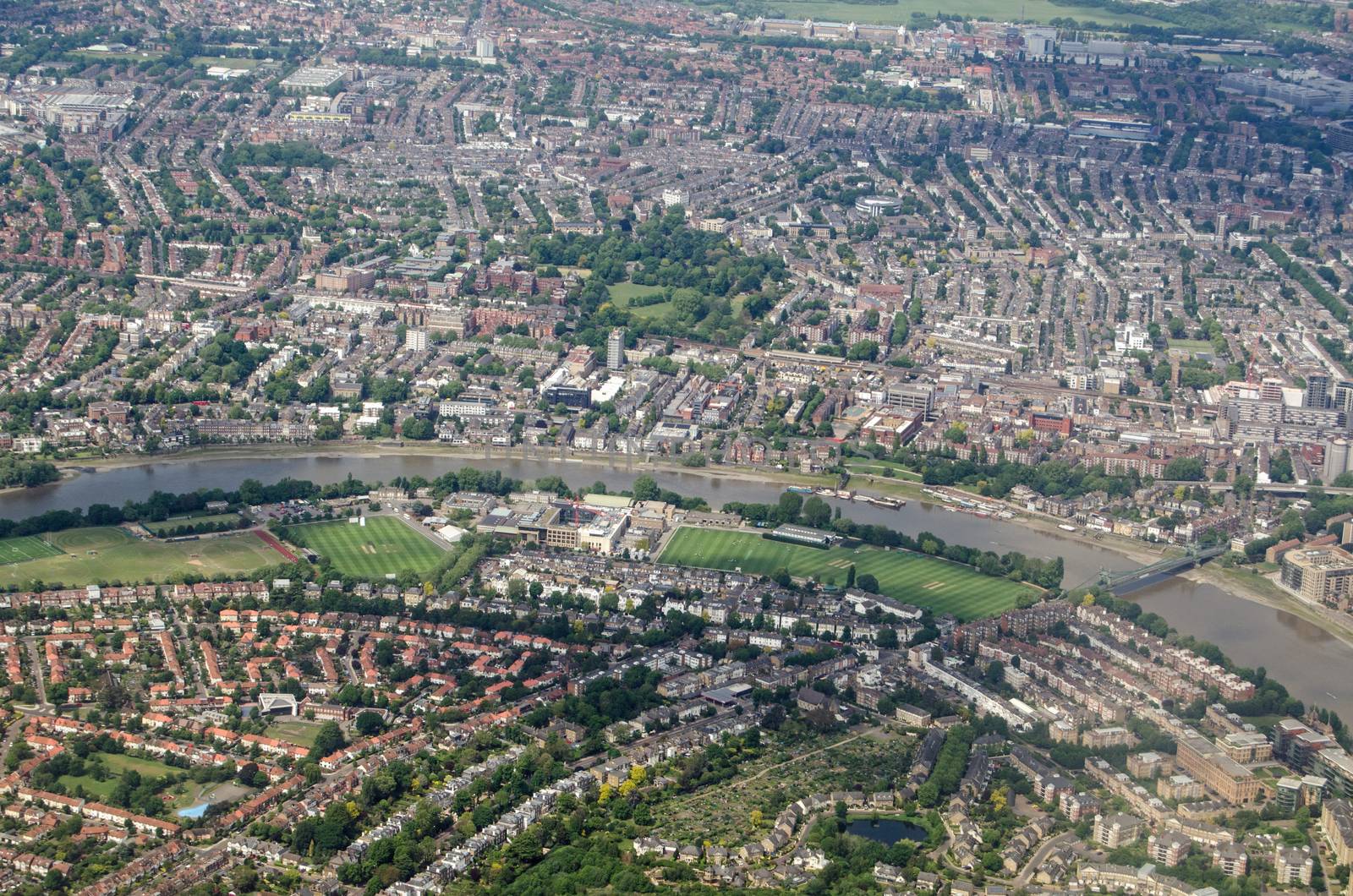 Aerial view of the River Thames as it flows between Barnes and Hammermith on a sunny summer day.