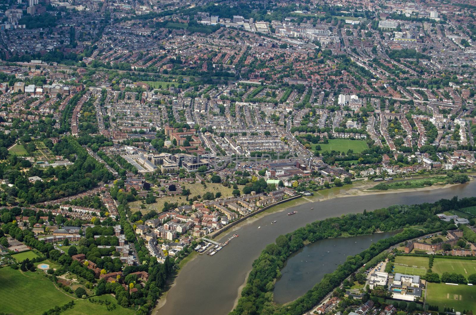Aerial view of the River Thames as it flows between Chiswick and Barnes in West London on a sunny summer day.  The Leg O Mutton pond is to the bottom of the image with the historic Chiswick House north of the river.
