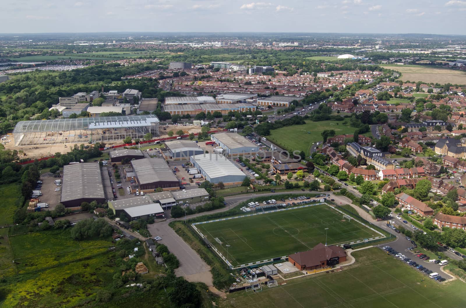 Aerial view of the CB Hounslow Sports Club and Heathrow International Trading Estate in West London on a sunny summer day.