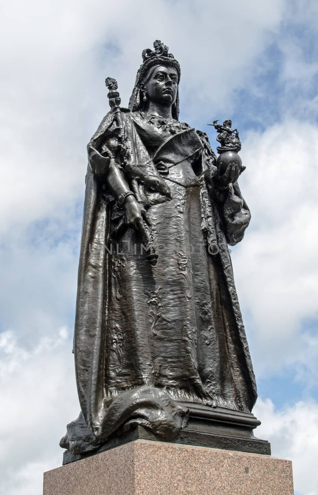 Full length statue of Queen Victoria wearing state robes and carrying an orb and sceptre.  Sculpted by Henry Price in 1904 and on public display at Sandhurst Military Academy in Berkshire.