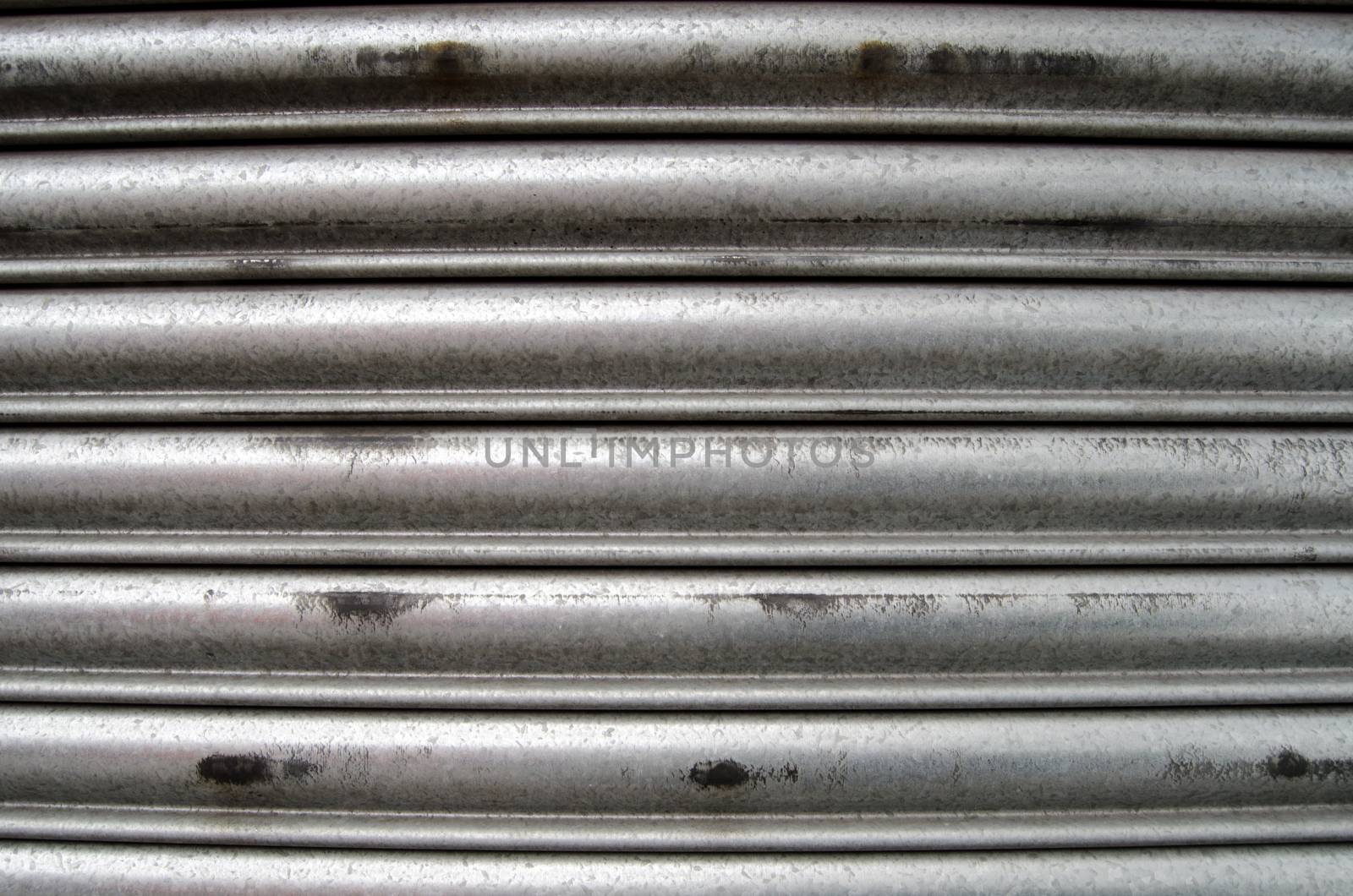 Detail of a closed metal security shutter.  Suitable for use as grunge background or wallpaper.