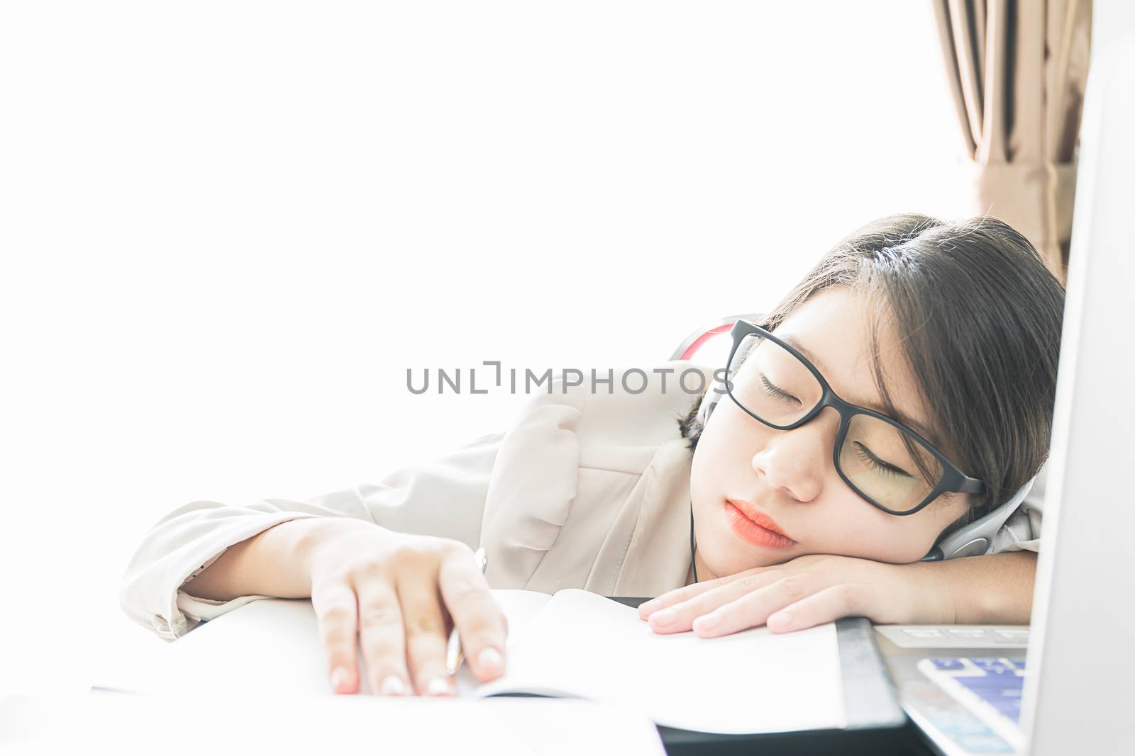 Teenage girl short hair sleep on desk after working on laptop while sit near window at home office