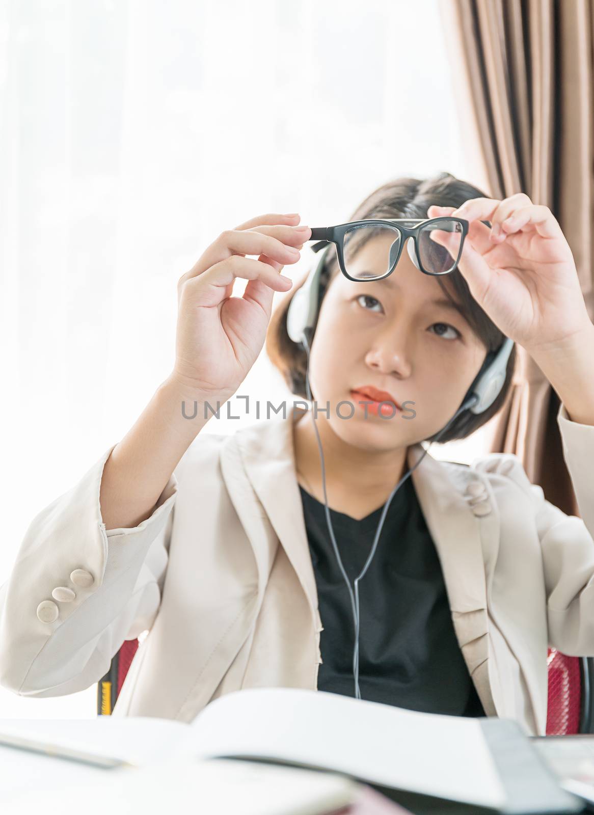 Teenage girl short hair in smart casual wear working on laptop while sit near window at home office