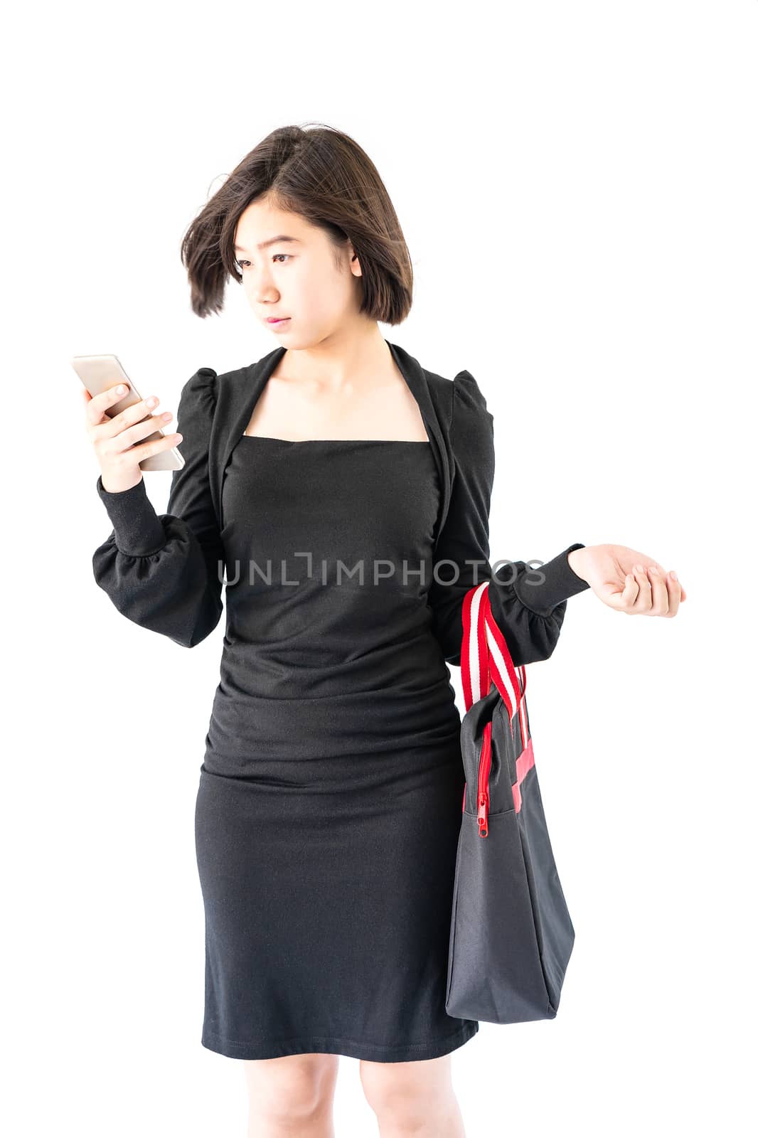 Woman carrying a black shopping bag using cellphone shopping online isolate on white background