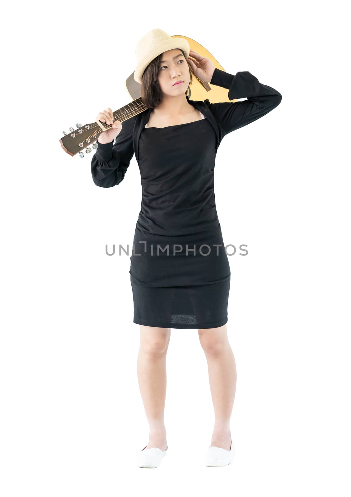 Woman carrying acoustic guitar on shoulder isolate on white background