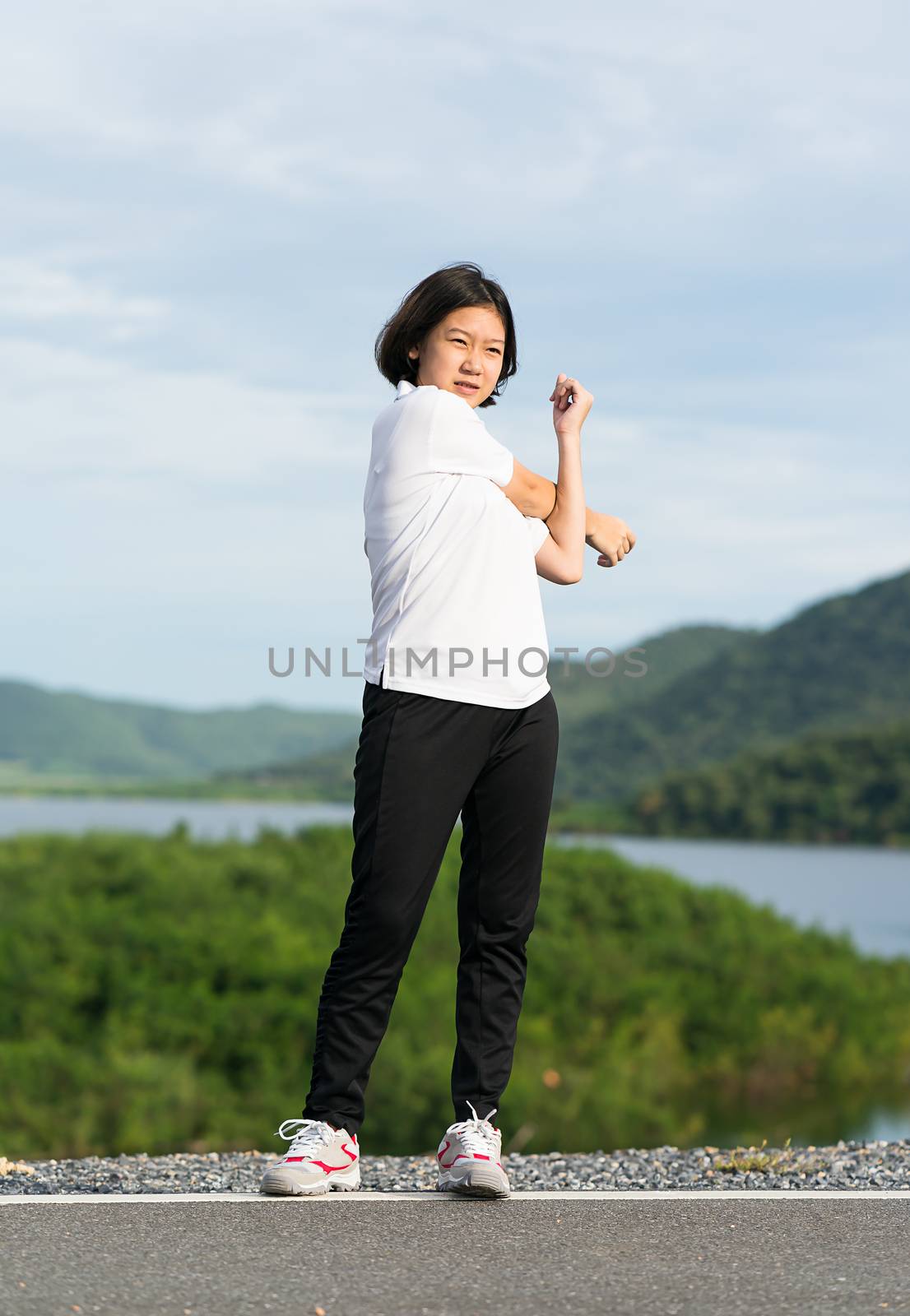 Woman doing exercising and warm up outdoor by stoonn