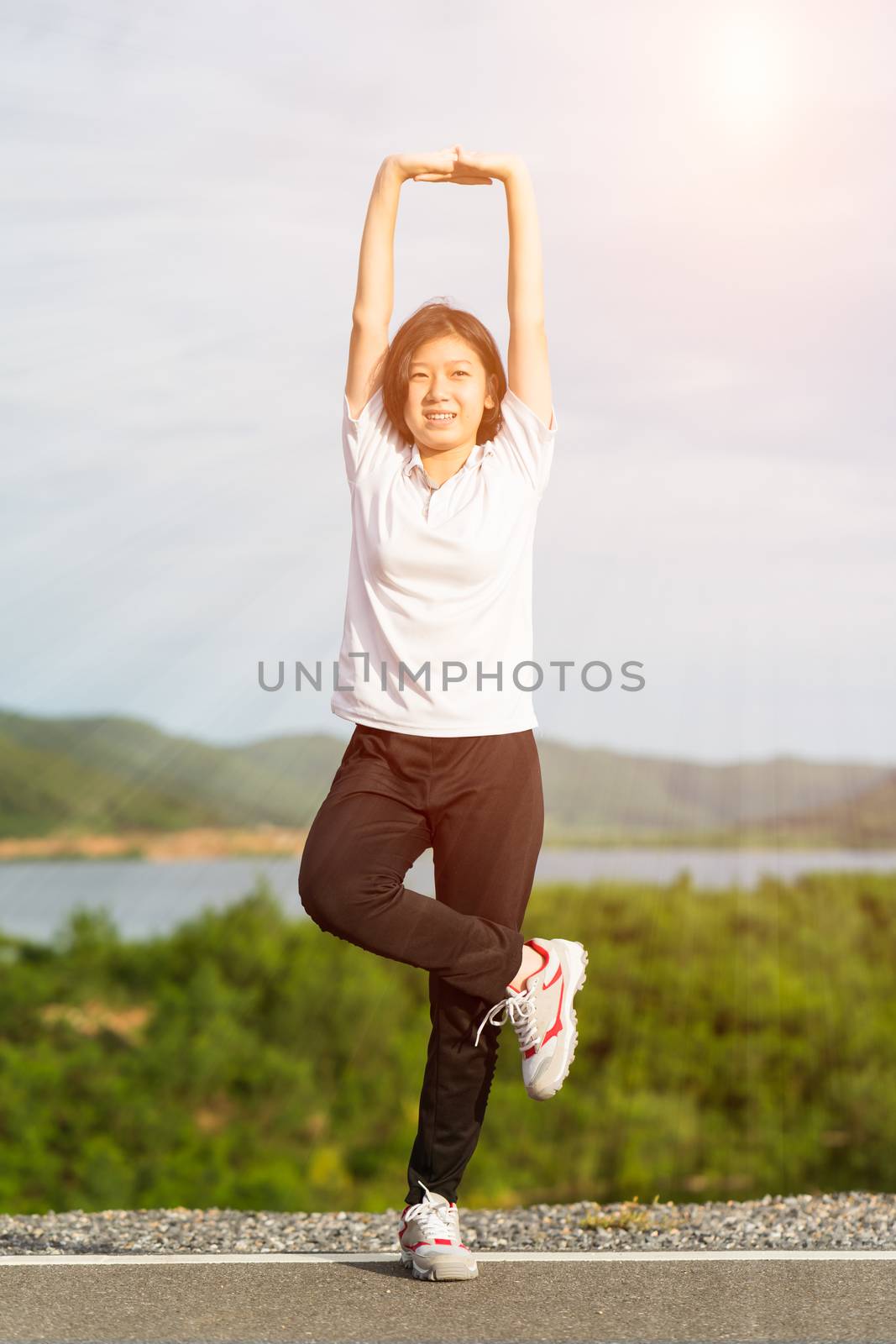 Woman doing exercising and warm up outdoor by stoonn