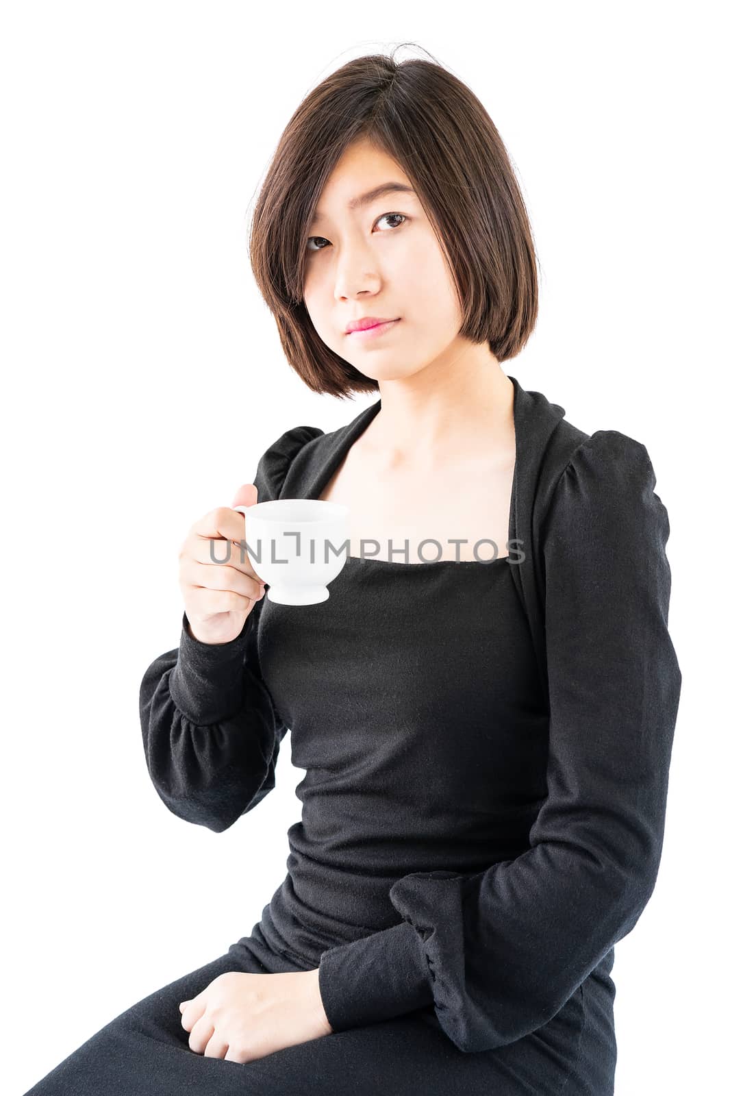 Young woman sittng holding coffee cup on white background