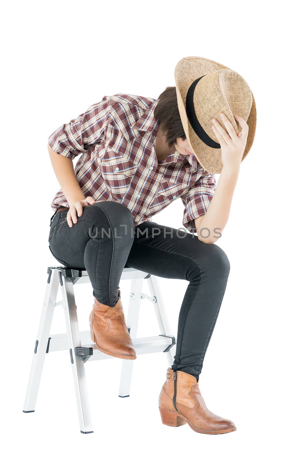 Young woman in a plaid shirt posing in studio on white backgroun by stoonn