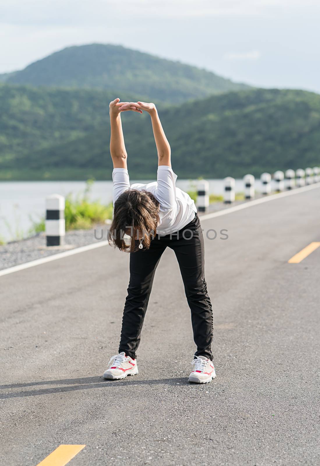 Woman short hair doing exercising outdoor by stoonn