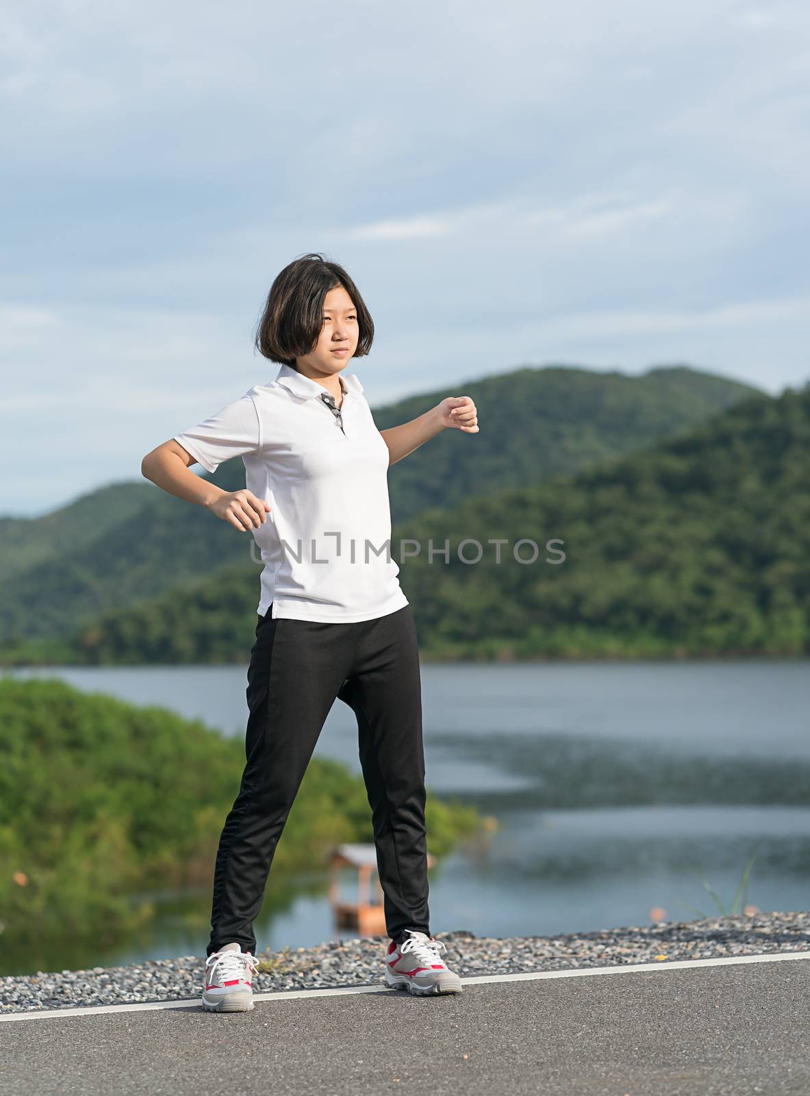 Woman short hair doing exercising outdoor by stoonn