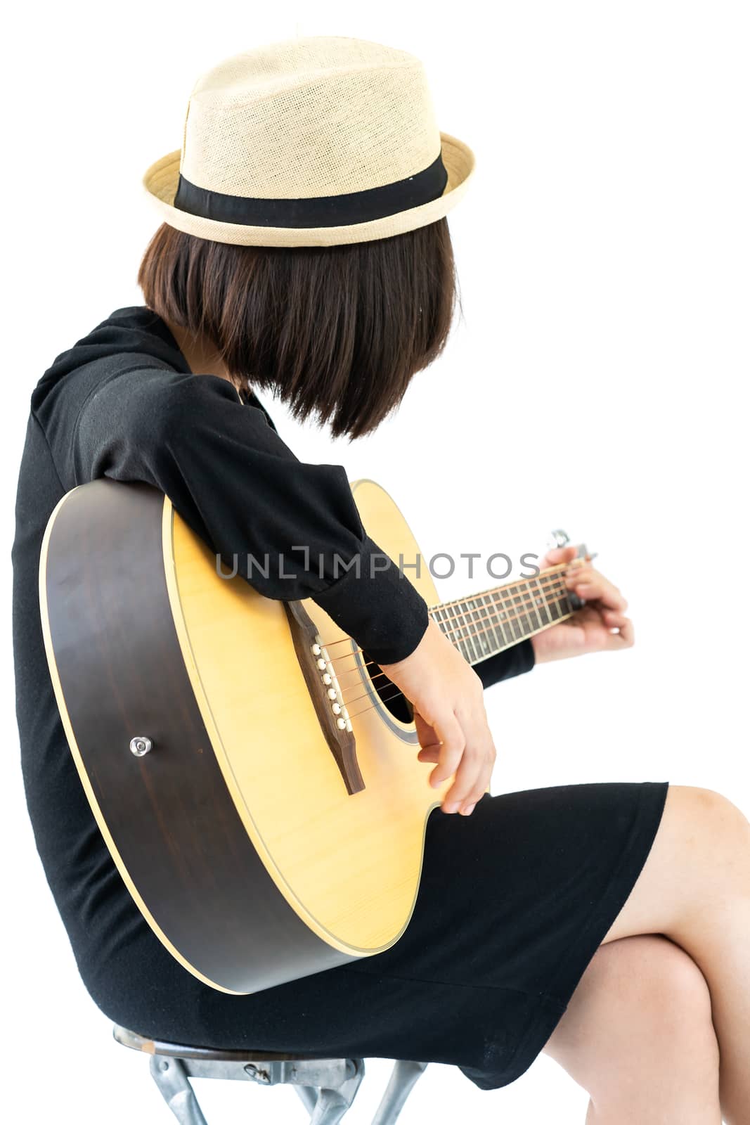 Young asia woman sitting and playing guitar guitar folk song in her hand isolate on white background