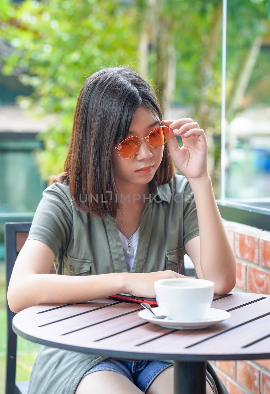 woman sitting in a cafe terrace by stoonn