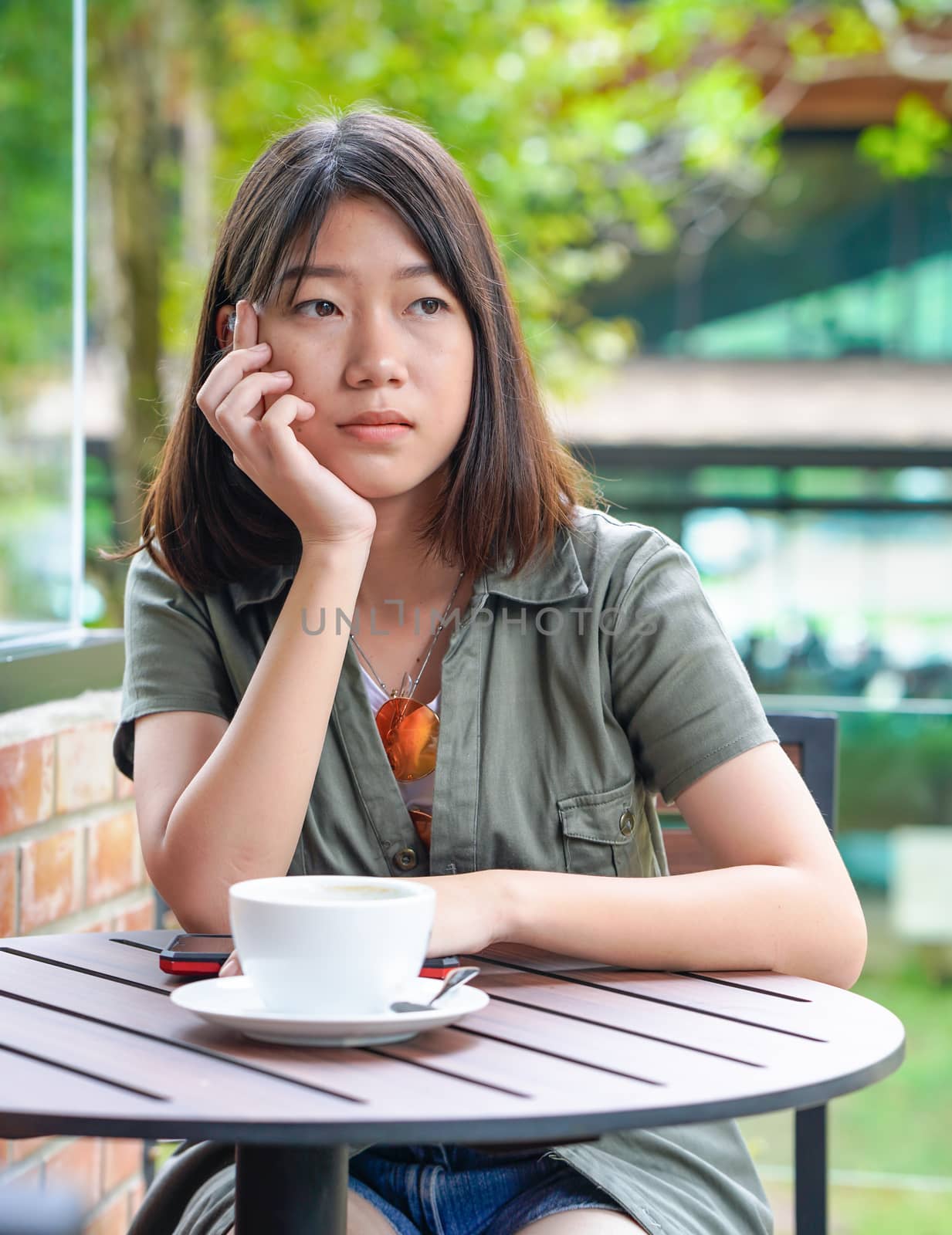 Pretty woman sitting in a cafe terrace with coffee cup