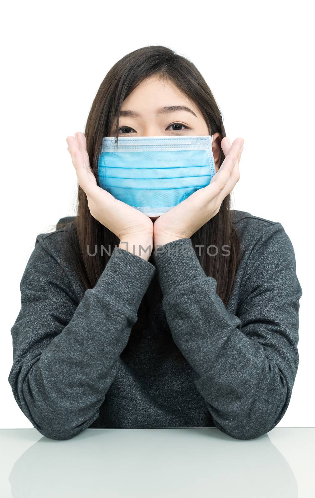 Close up woman long hair propping up chin with his hands and wearing protective mask for protection against virus Covid-19 on white