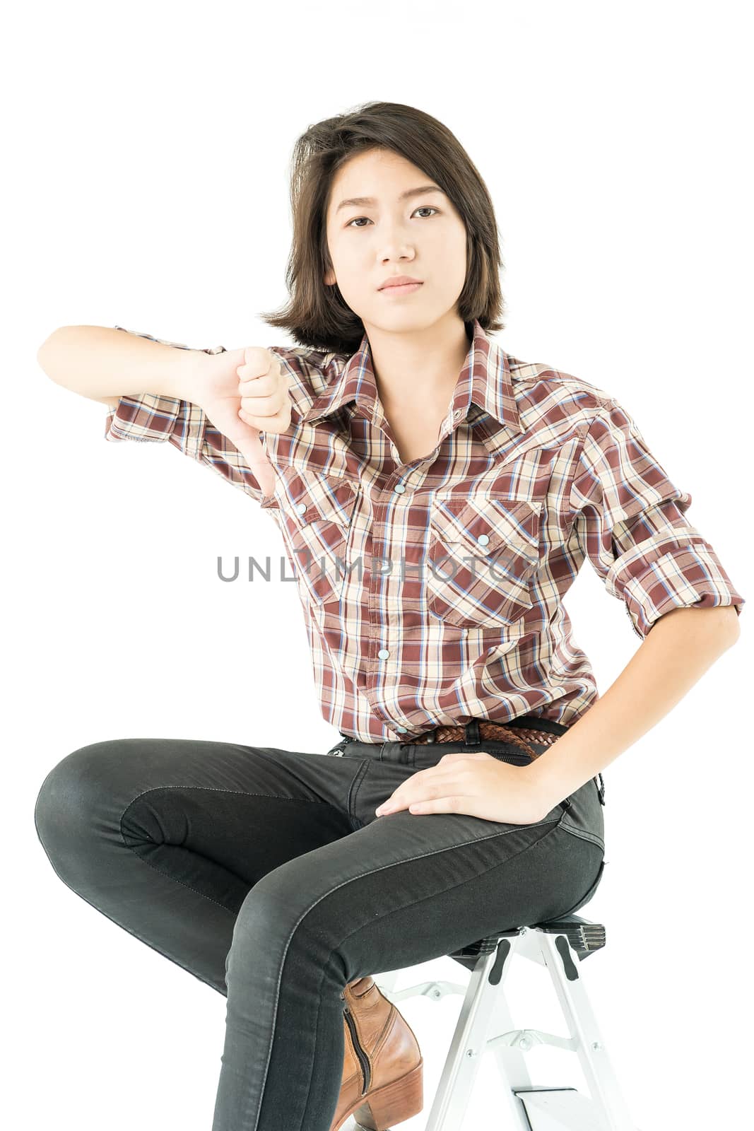 Young pretty woman in plaid shirt posing in studio with isolated on white background