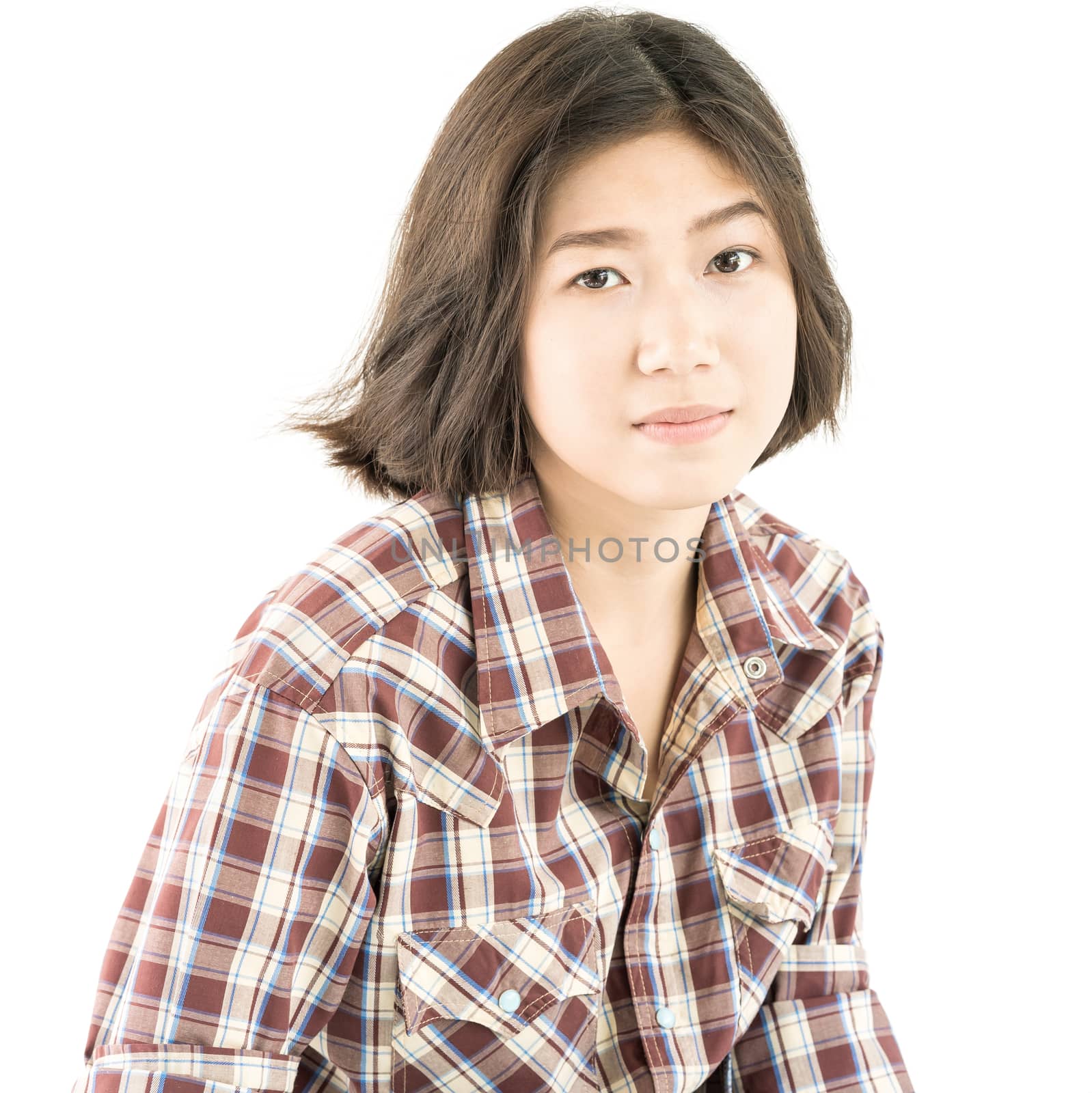 Young woman in a plaid shirt posing in studio on white  by stoonn