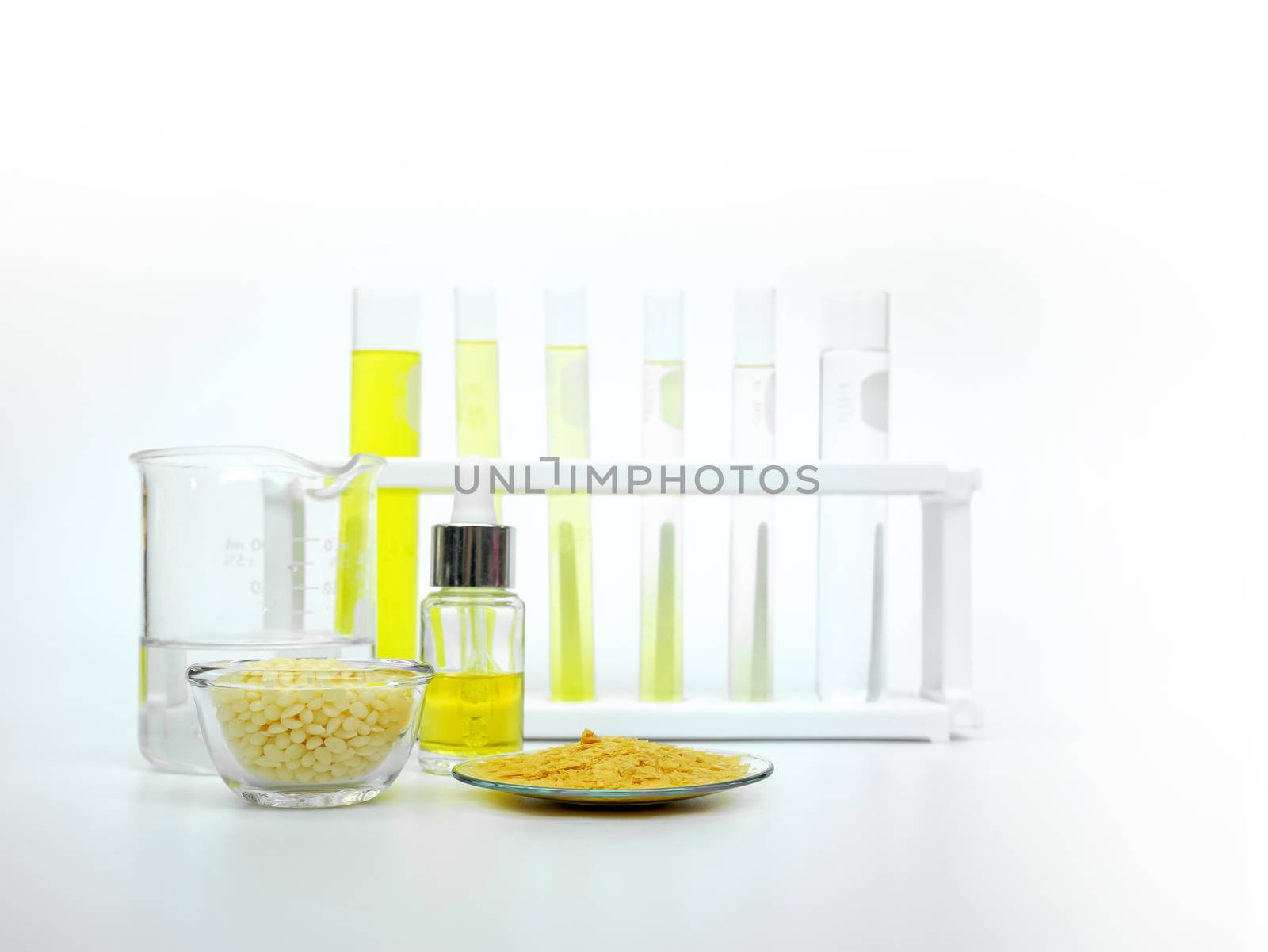 Cosmetic chemicals ingredient on white laboratory table. Carnauba Wax Flakes by chadchai_k