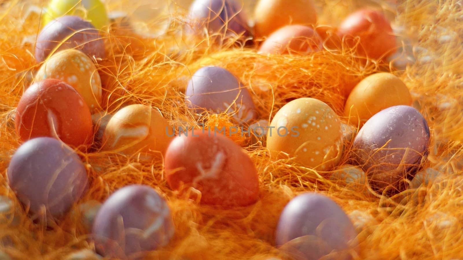 Mulicoloured Painted Easter eggs in decorative mesh.Easter background for holiday. by andre_dechapelle