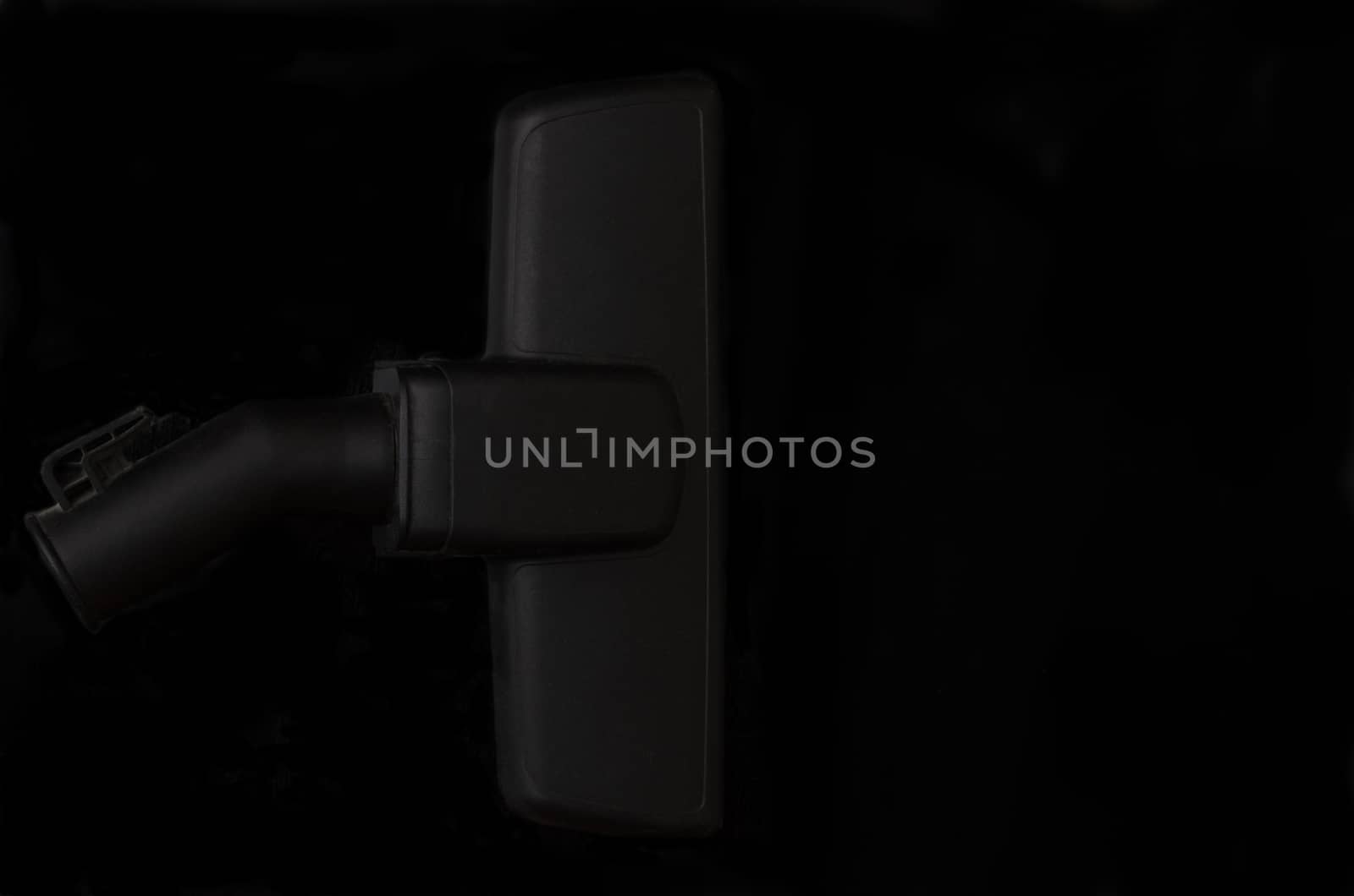 Vacuum cleaner brush om black background.Minimalictic black cleaning element