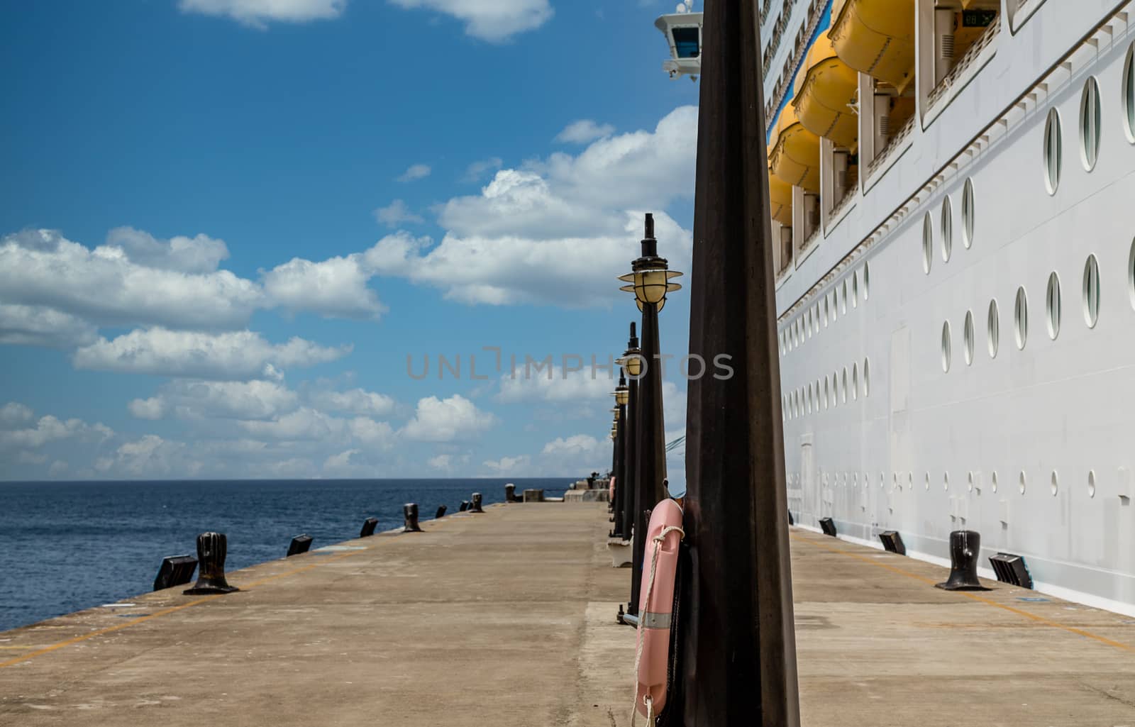 Light Posts on Pier by Cruise Ship by dbvirago