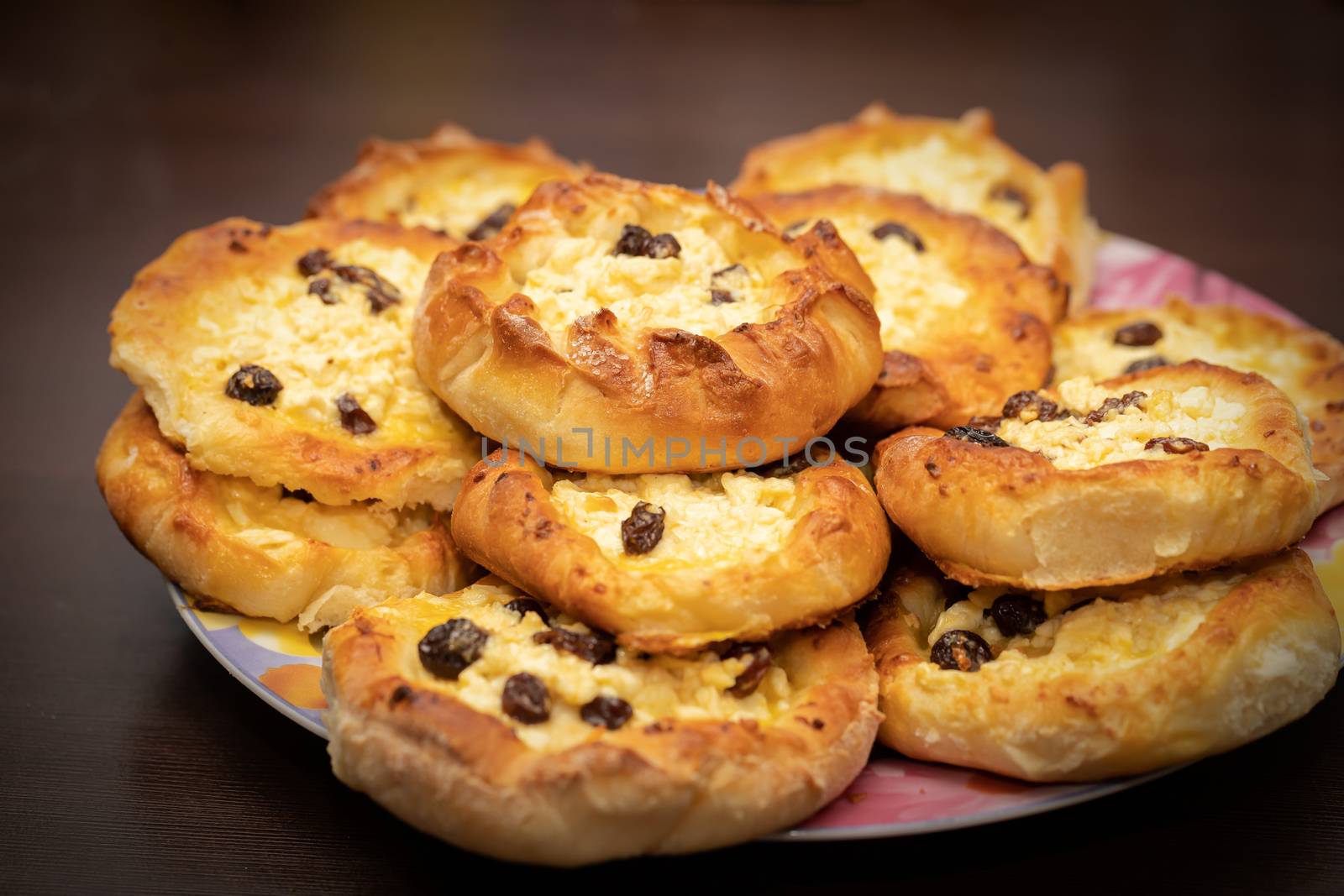 Fresh homemade open patties with cottage cheese (traditional Russian pastry vatrushka, round buns, curd tart) on linen napkin, white background, selective focus, closeup