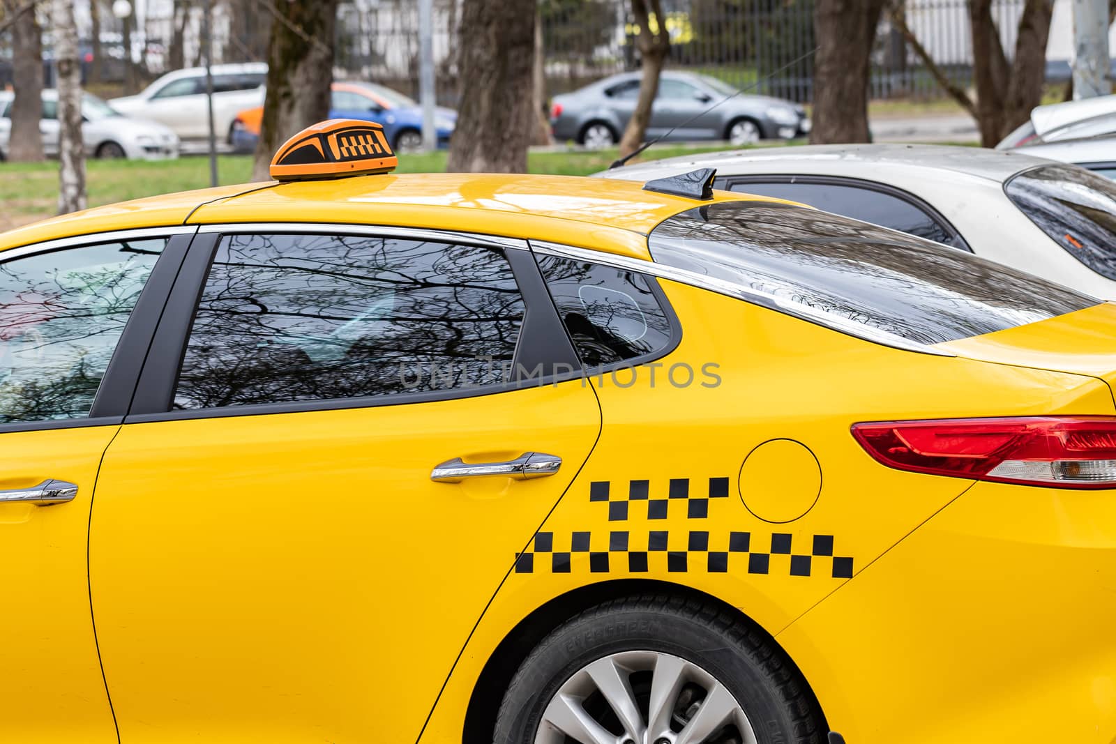 Taxi sign on the roof of a car close-up on a Sunny day.